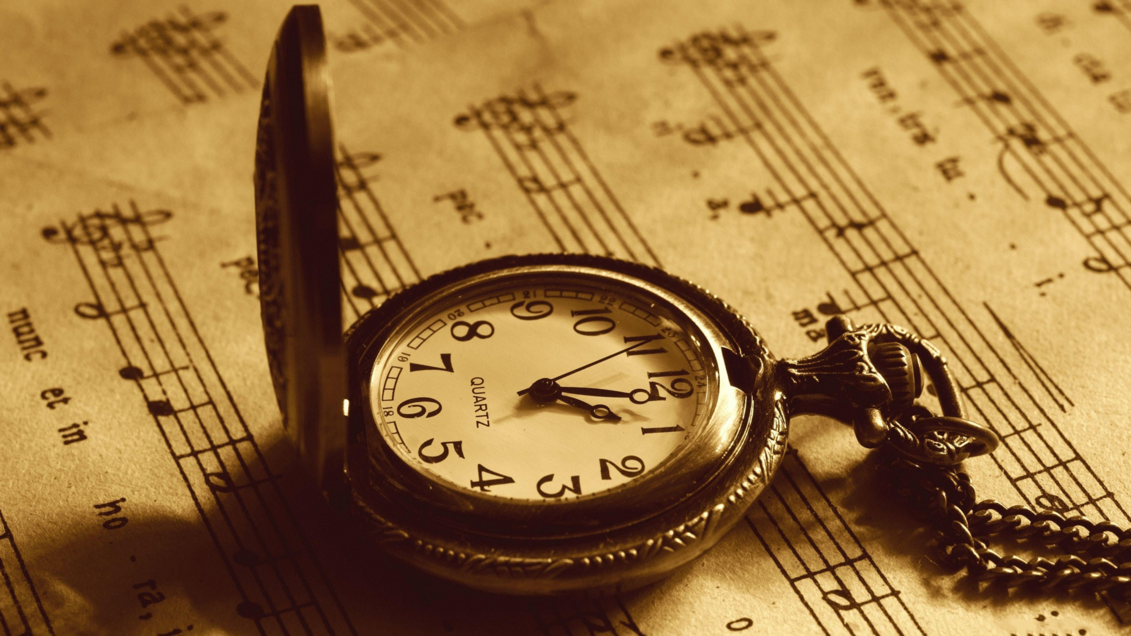 Pocket clock on a music book - Old Clock Wallpaper Download 3840x2160