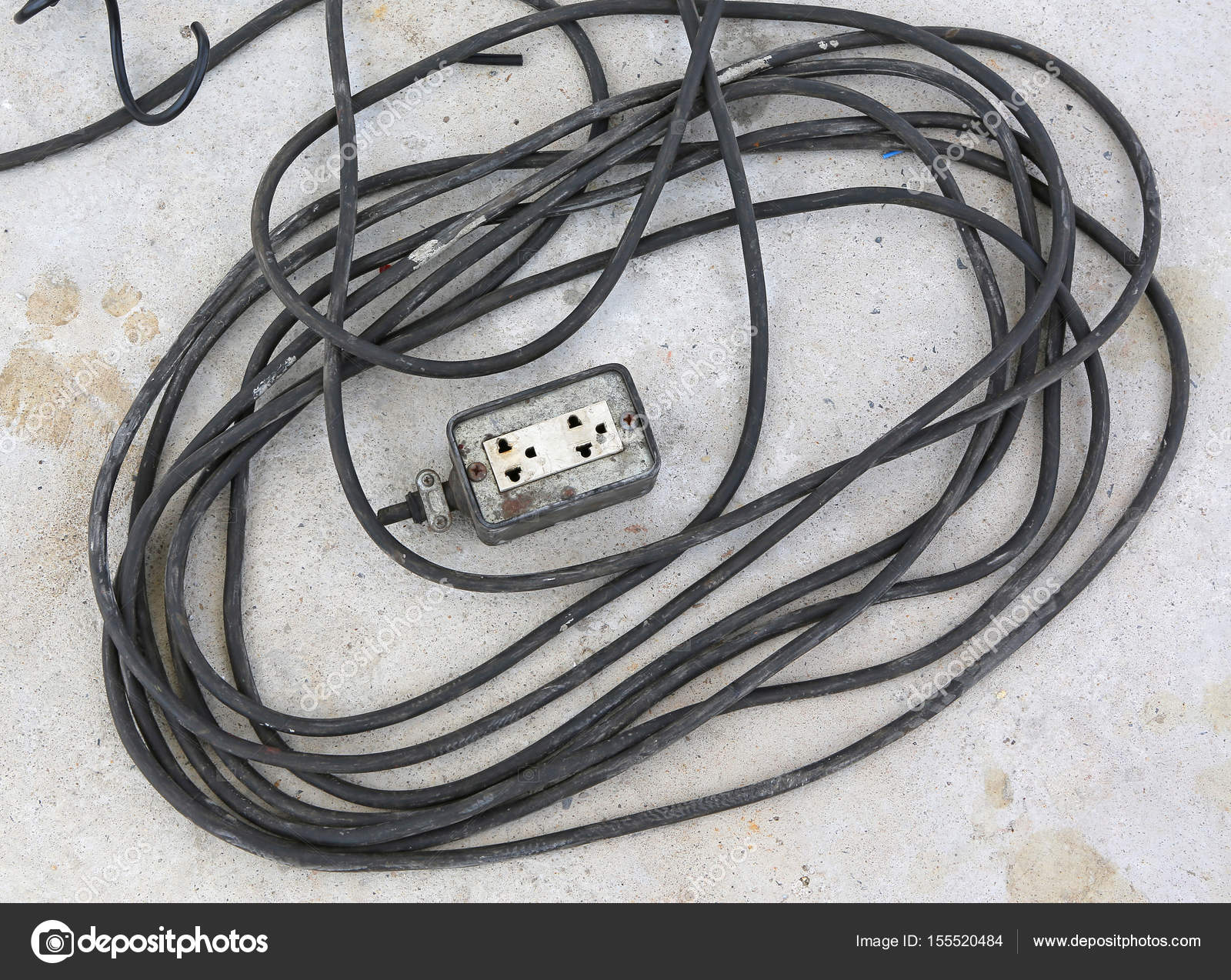 Old and damaged electrical wire on cement ground — Stock Photo ...