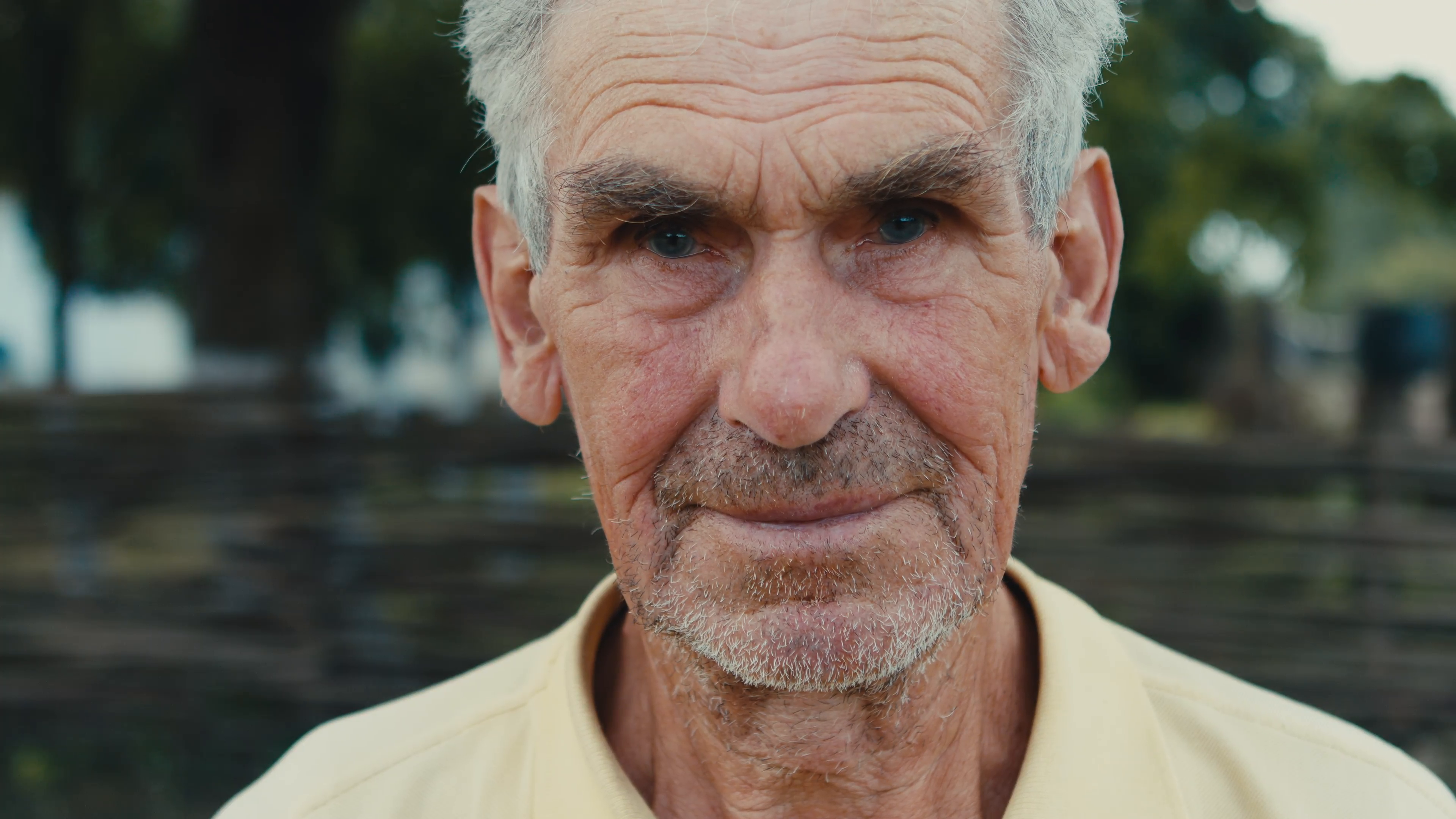 Portrait of old wrinkled and gray-haired old man with close. 4K RAW ...