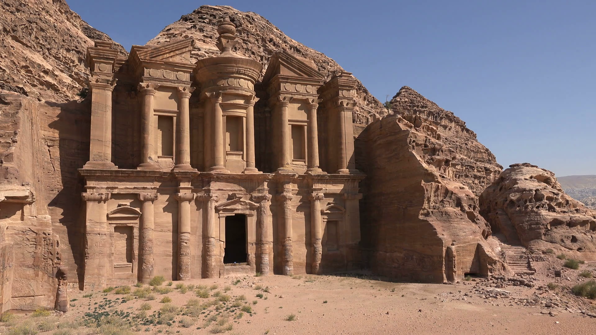 Old temple complex (Monastery) in stark desert landscape in Petra ...