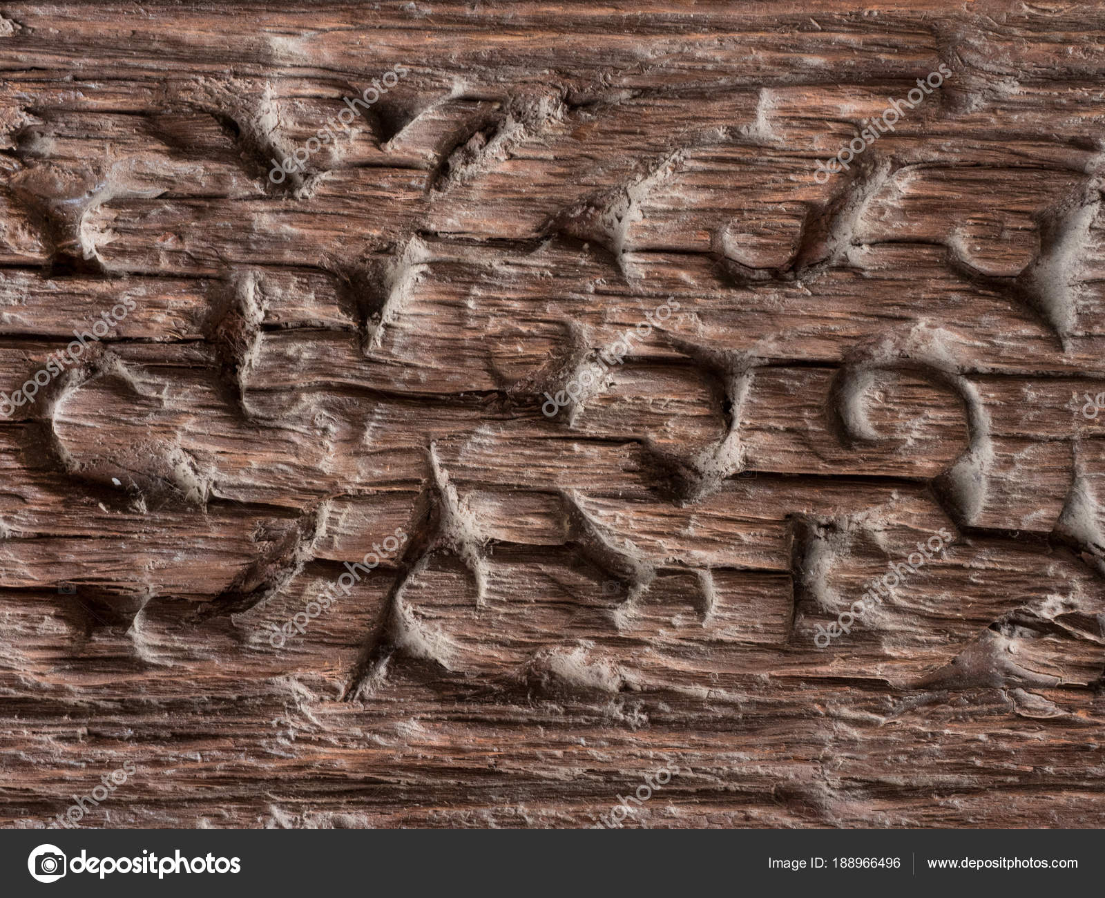 Fragment of old weathered wood with remains of old carving, brown ...