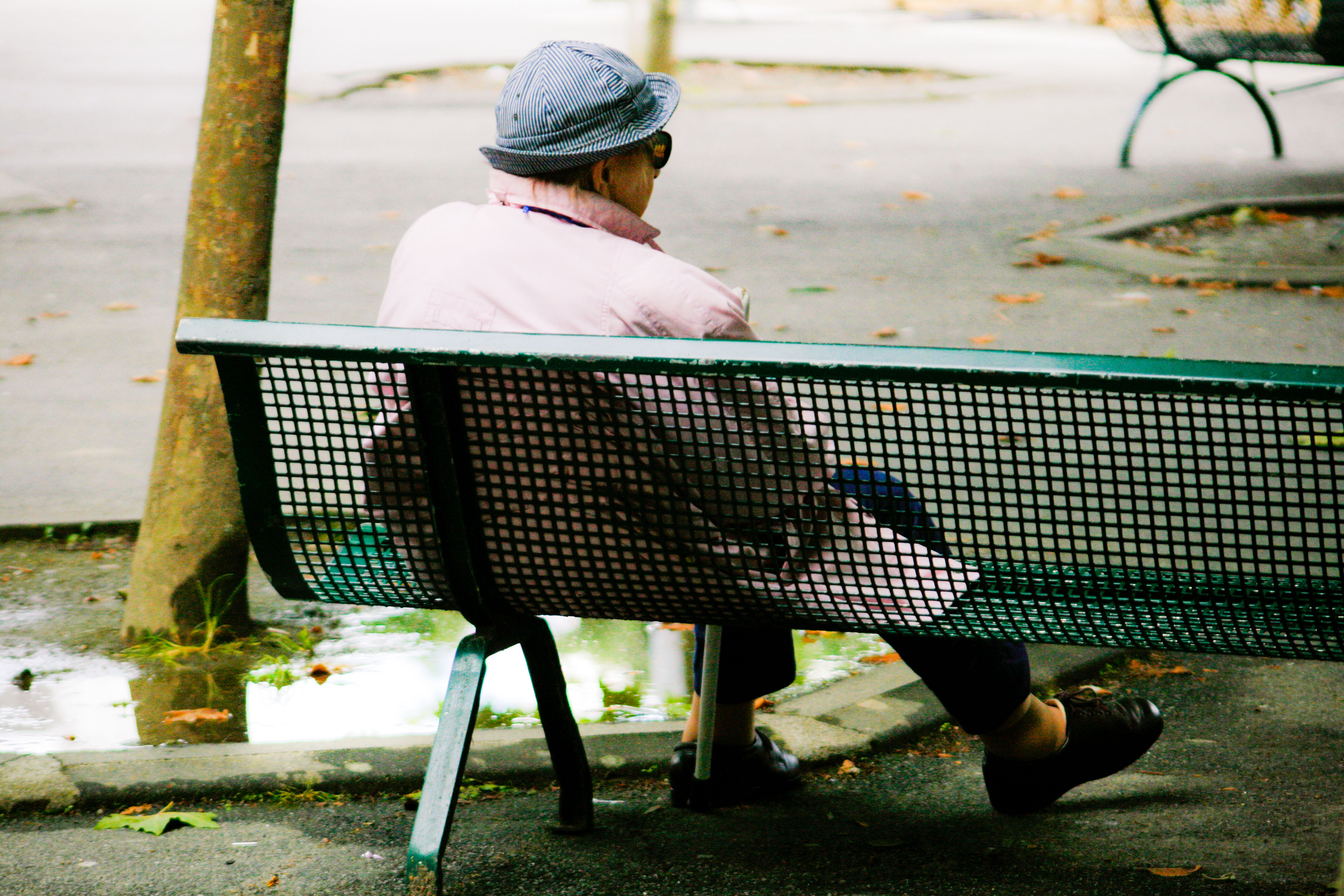 Old woman sitting on bench photo