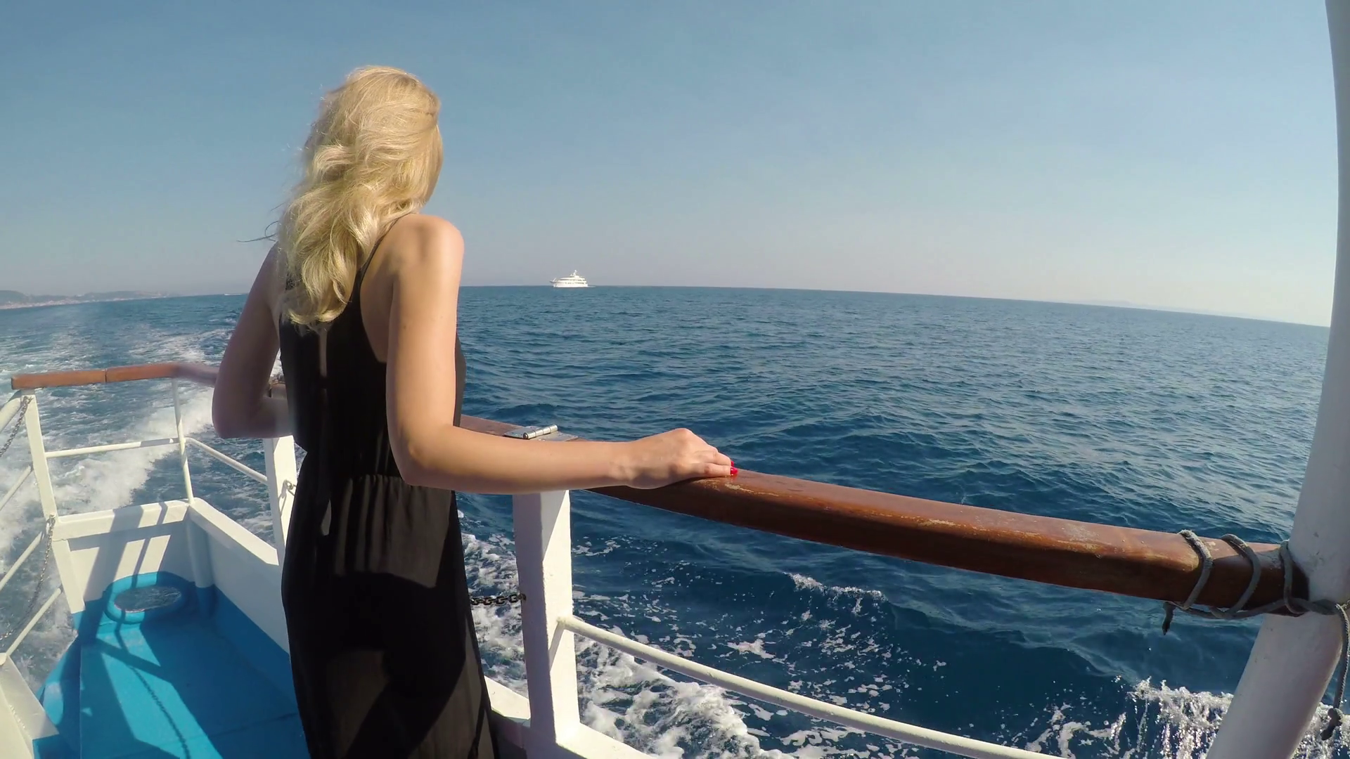 Attractive blonde woman tourist on boat watching the sea enjoying ...