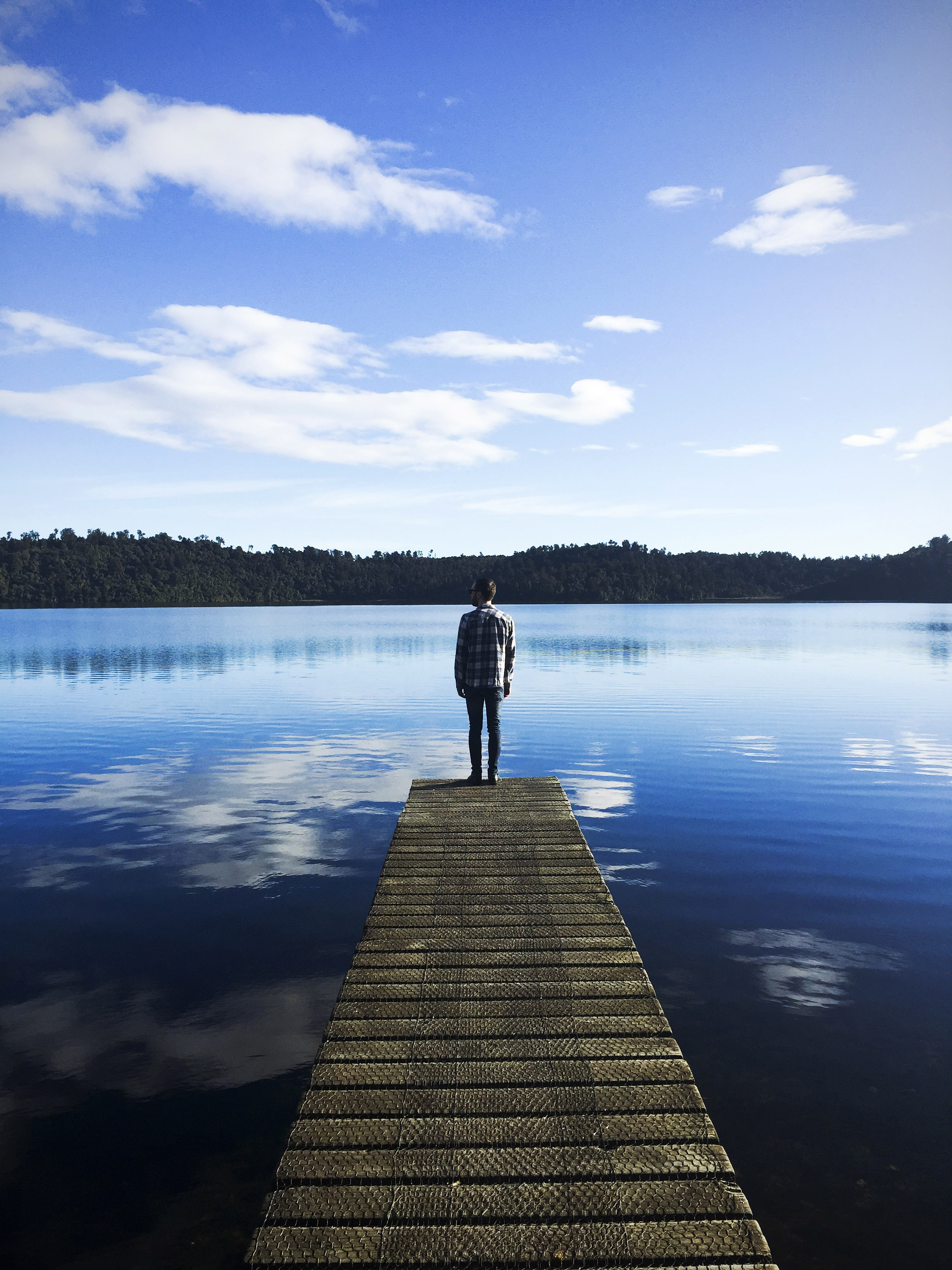 Man standing on the dock looking at the lake landscape image - Free ...