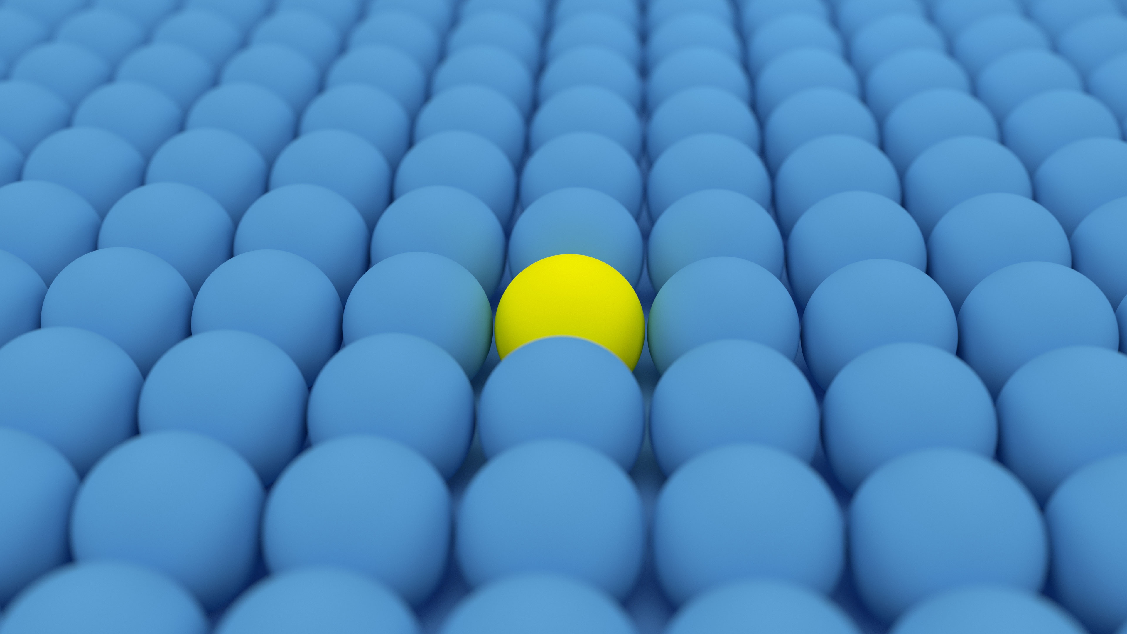 One yellow  ball among blue balls photo