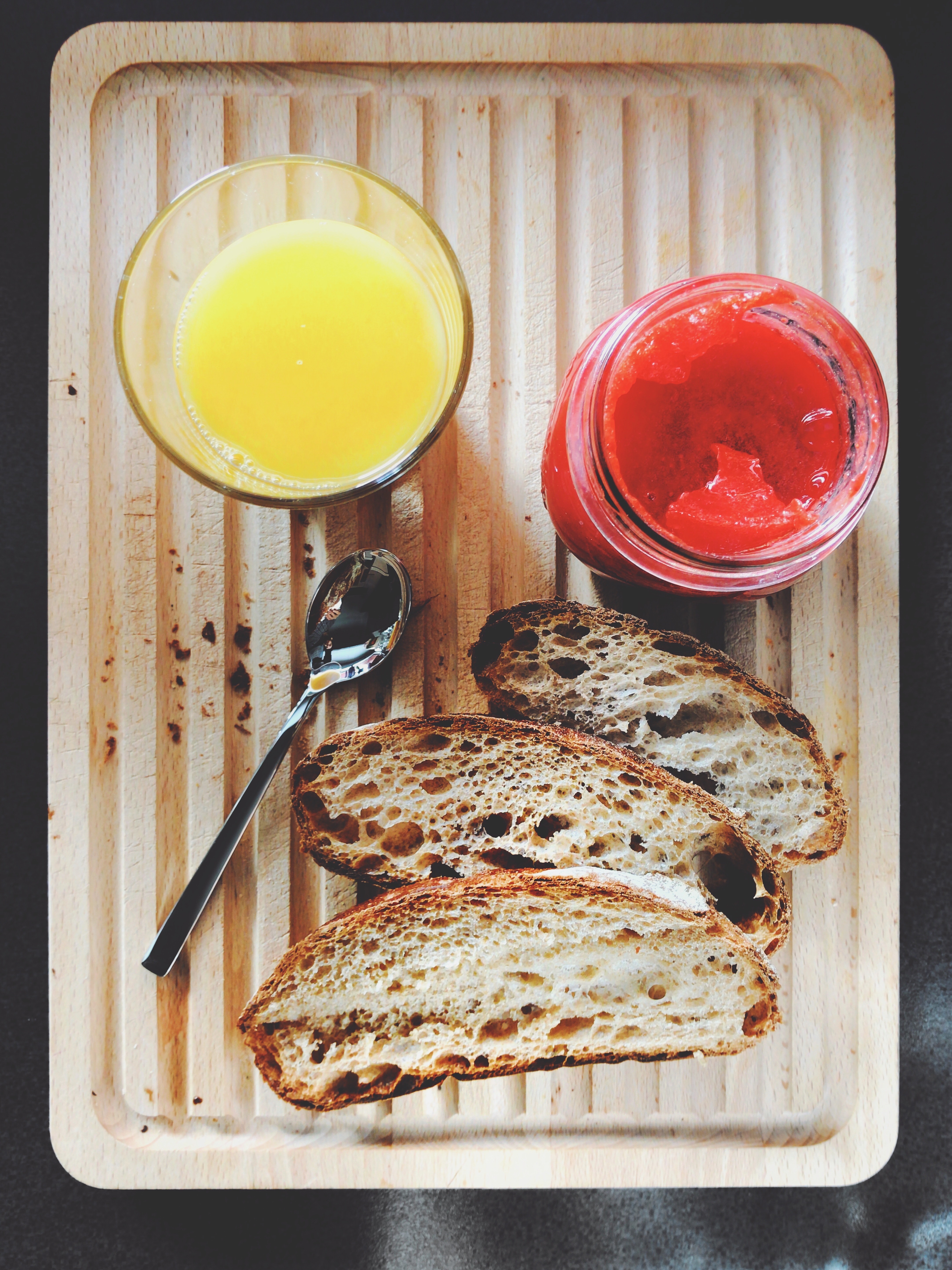 Orange juice, jam and bread photo