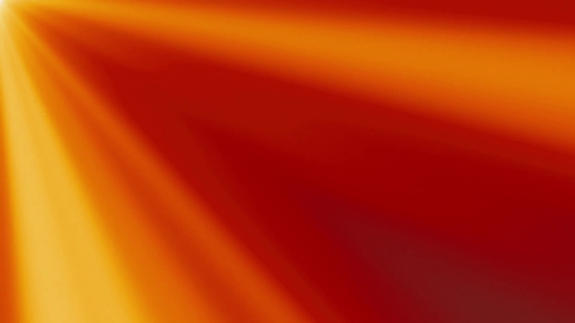 Looping clip of yellow and orange light rays on a red background ...
