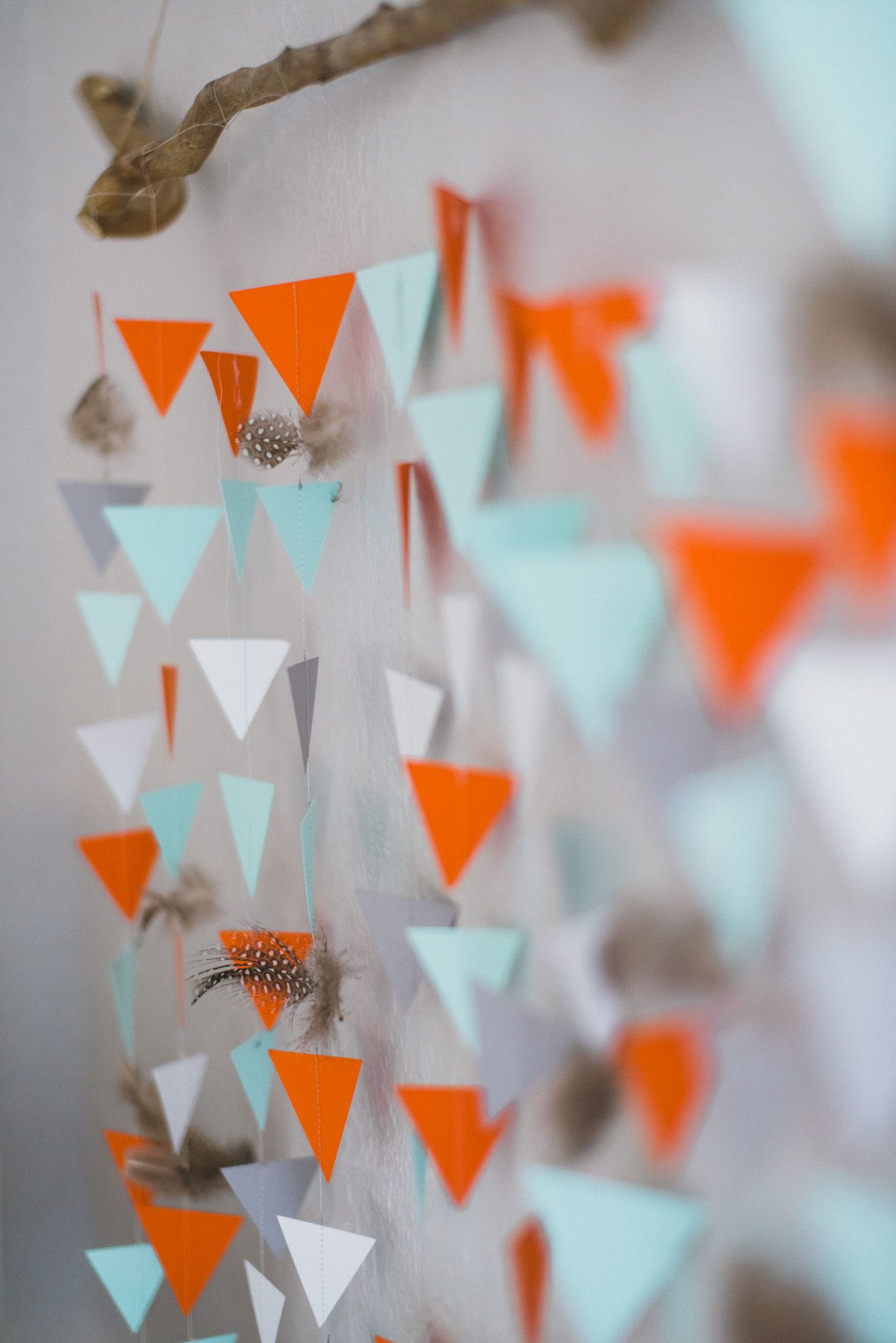 Detail of our DIY sewn paper triangle and feather garland wall ...