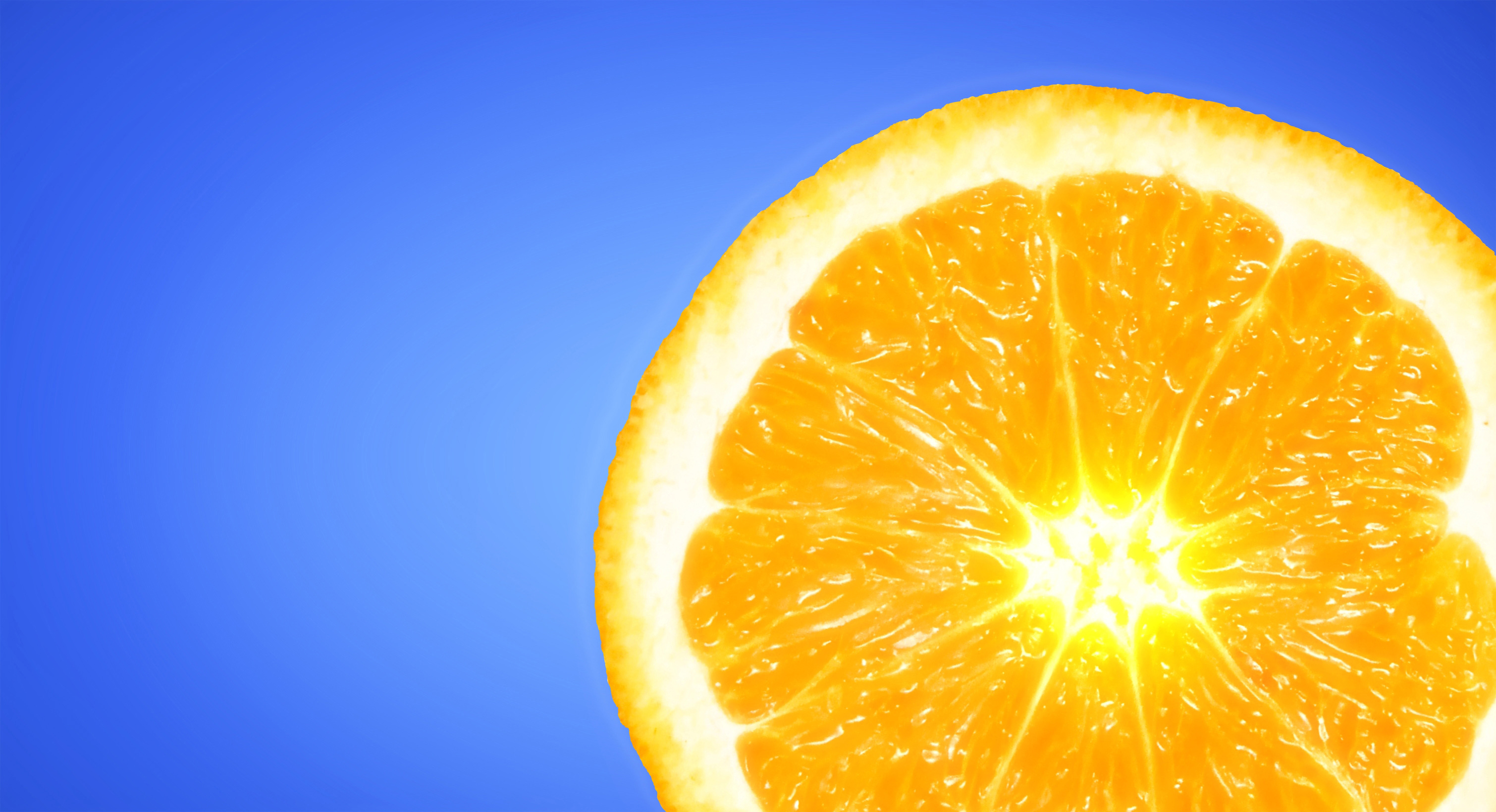 Orange slice on sky blue background photo