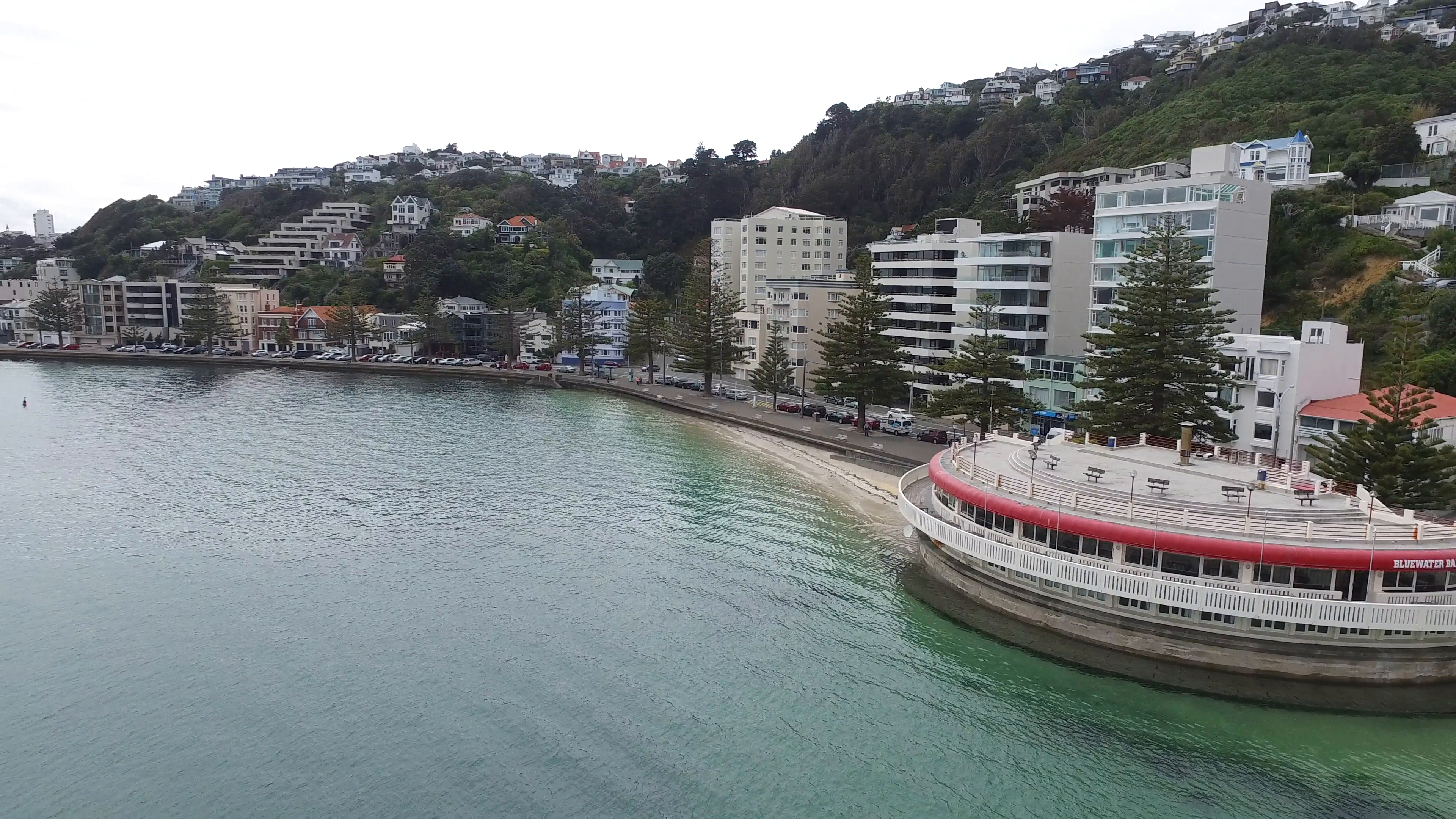 Aerial view of Oriental Bay Band Rotunda. Pan around out over Hutt ...