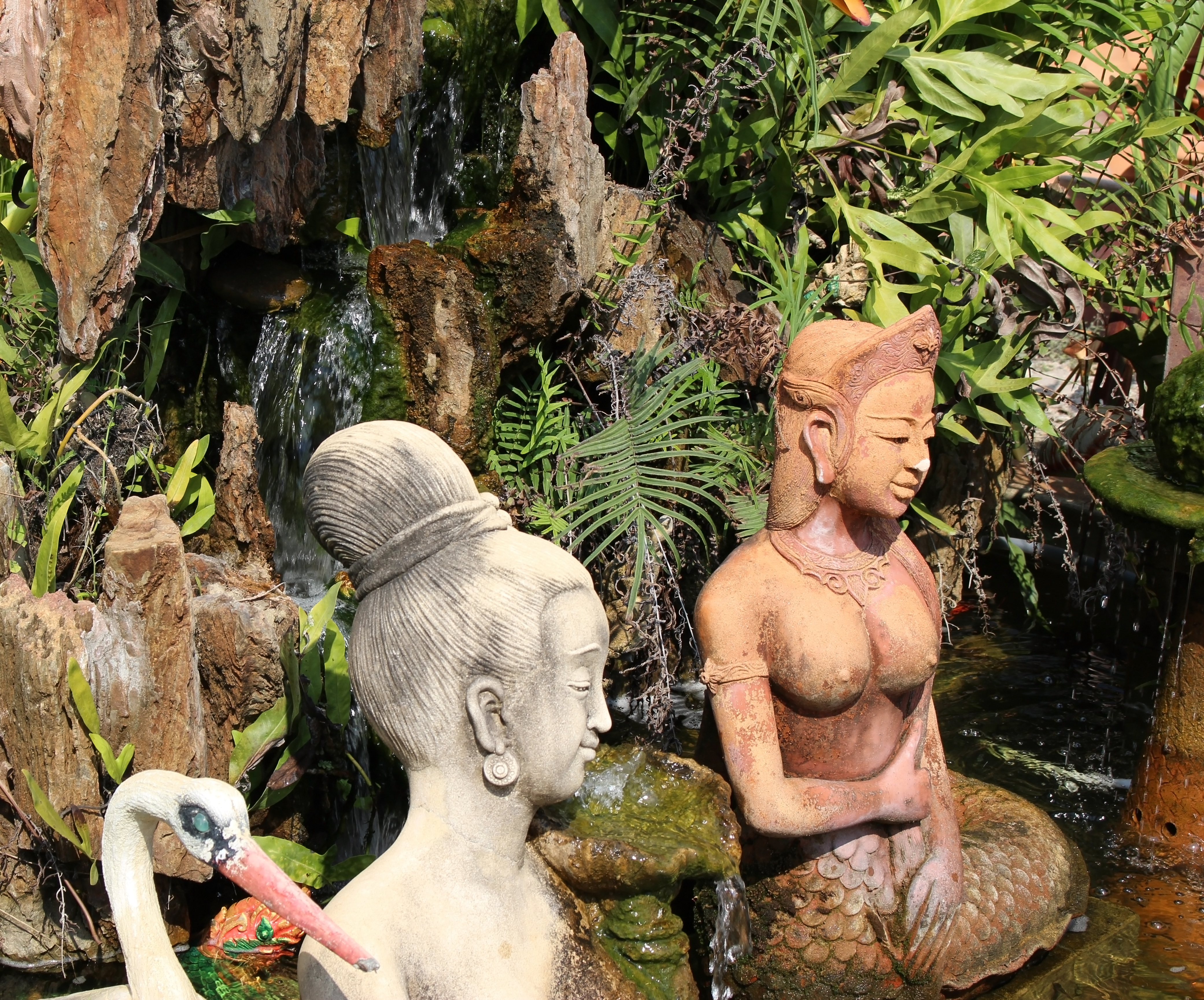 Oriental garden statue figurines in a water feature, asia photo