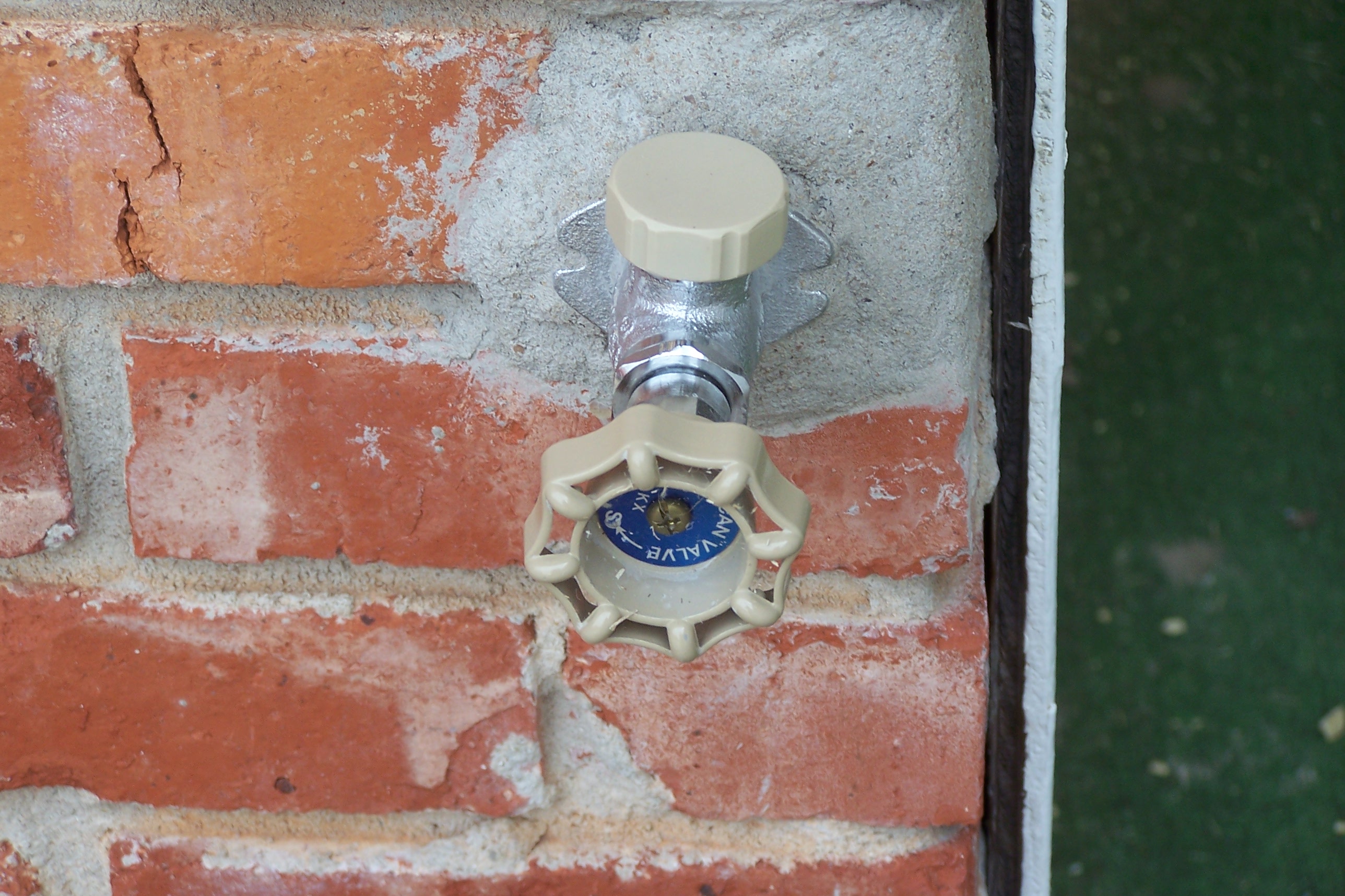 Outdoor water faucet on brick photo
