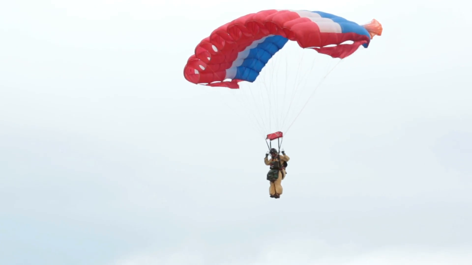 Firefighter fireman smoke jumper parachute landing. Wildfire burns ...