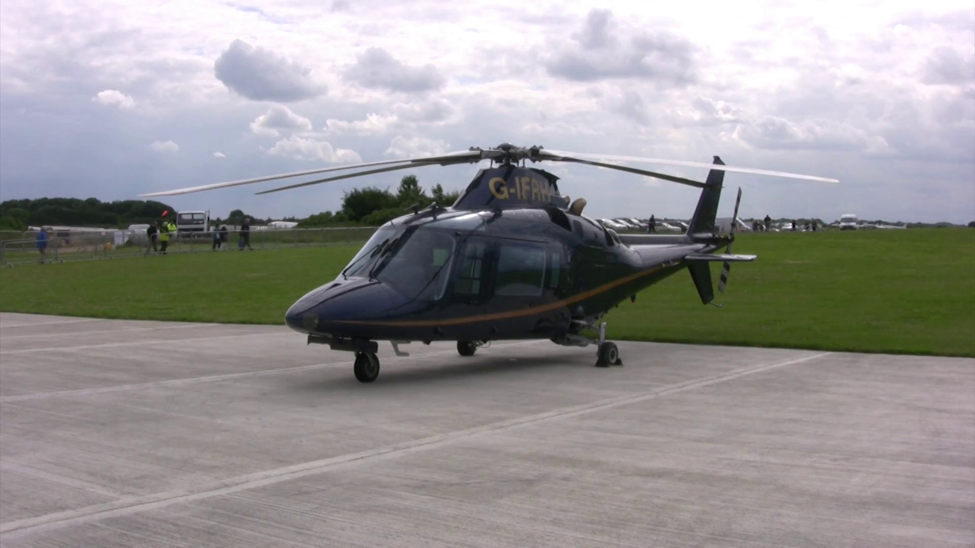 Black helicopter parked on tarmac at an airfield Stock Video Footage ...