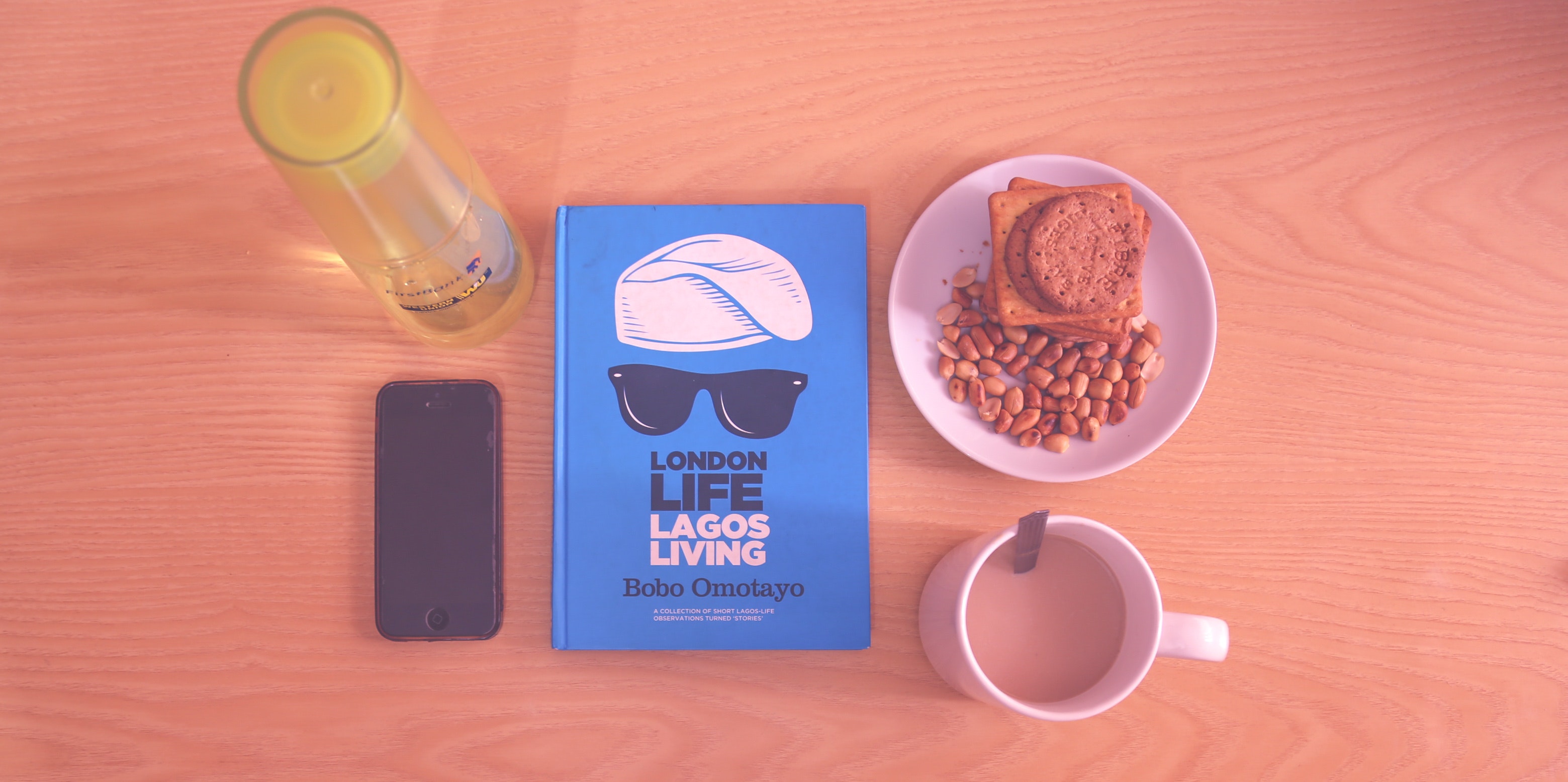 Peanuts and biscuits in white ceramic plate beside white ceramic mug near lagos living book photo