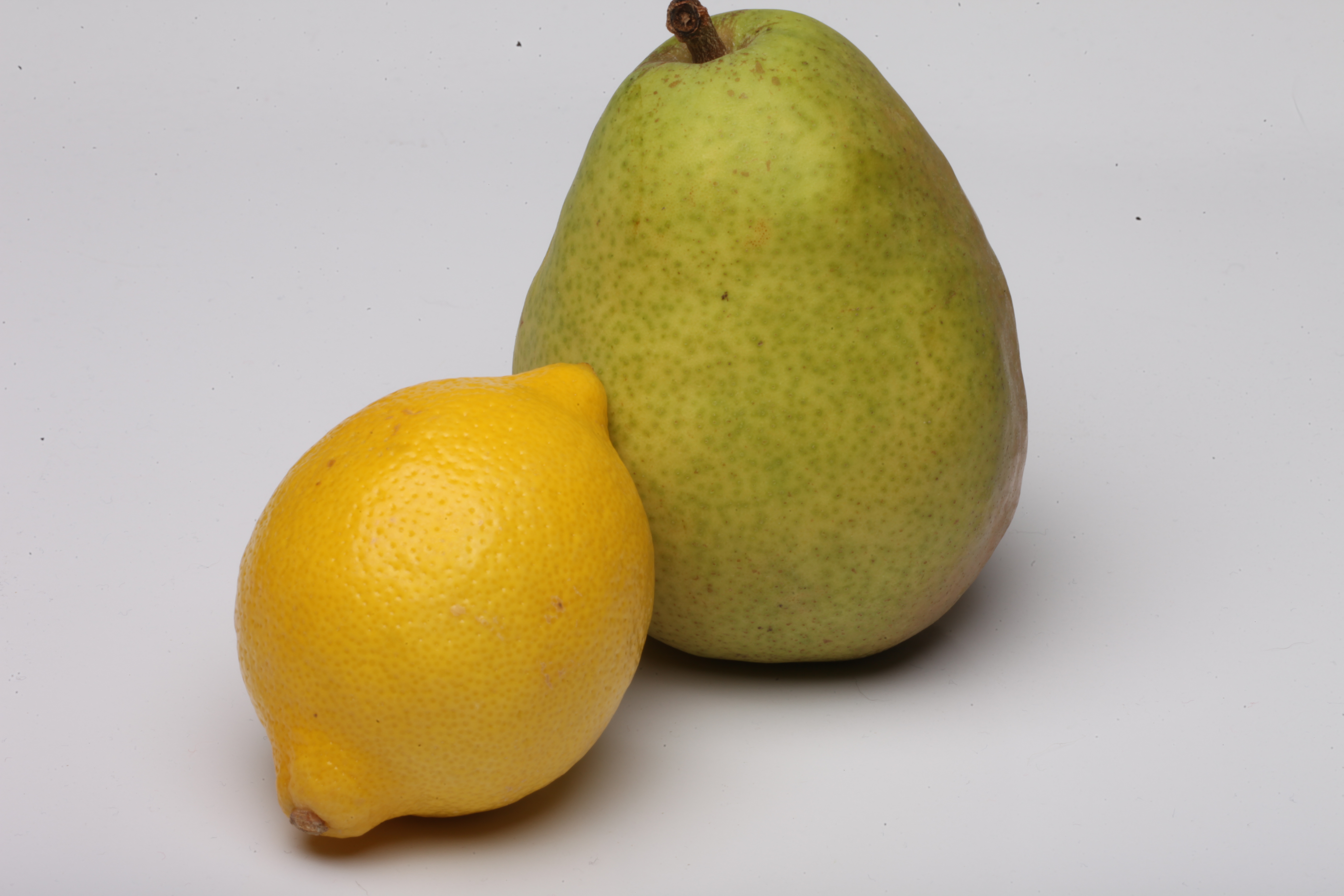 Pear and lemon isolated on white. photo