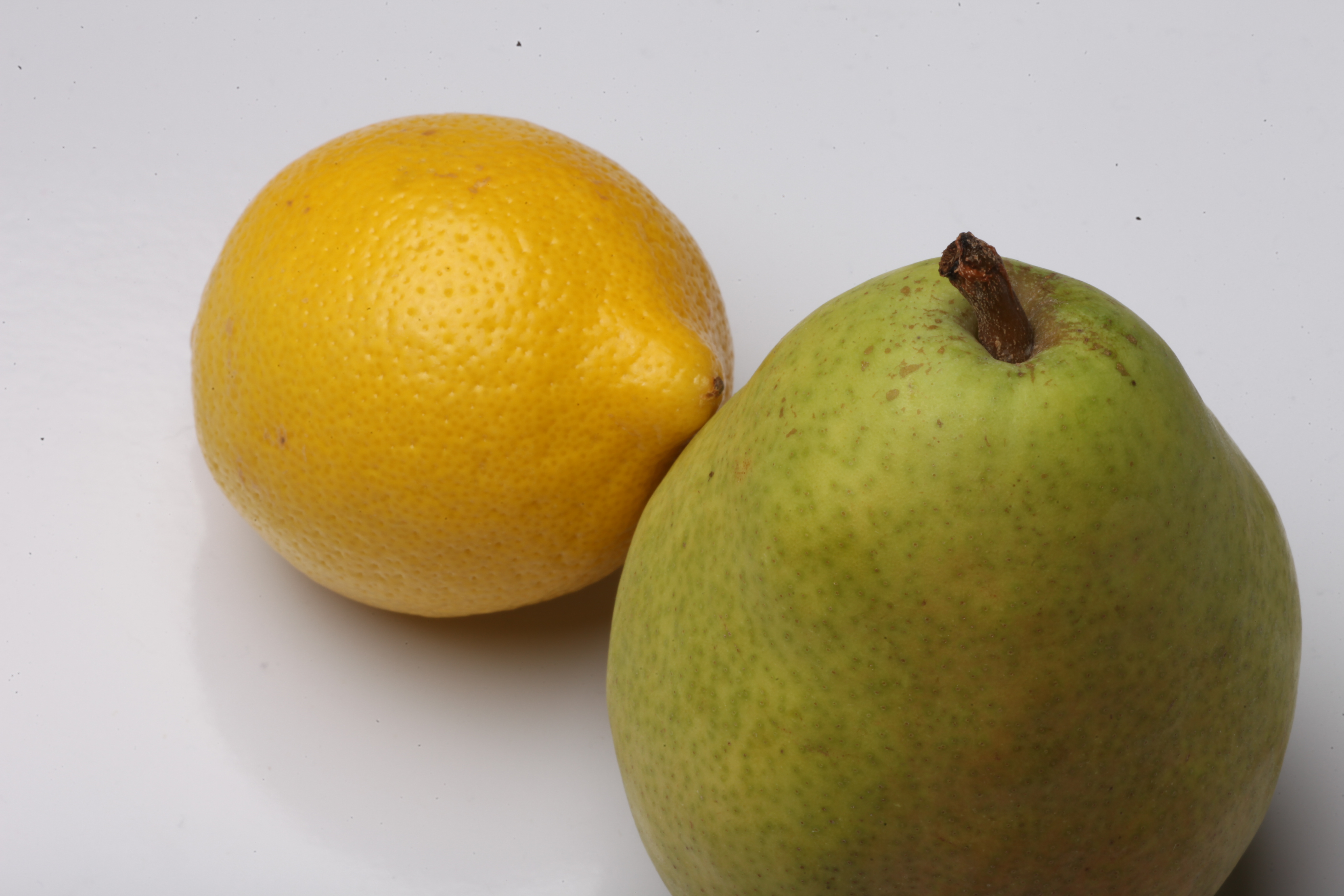 Pear and lemon isolated on white. photo