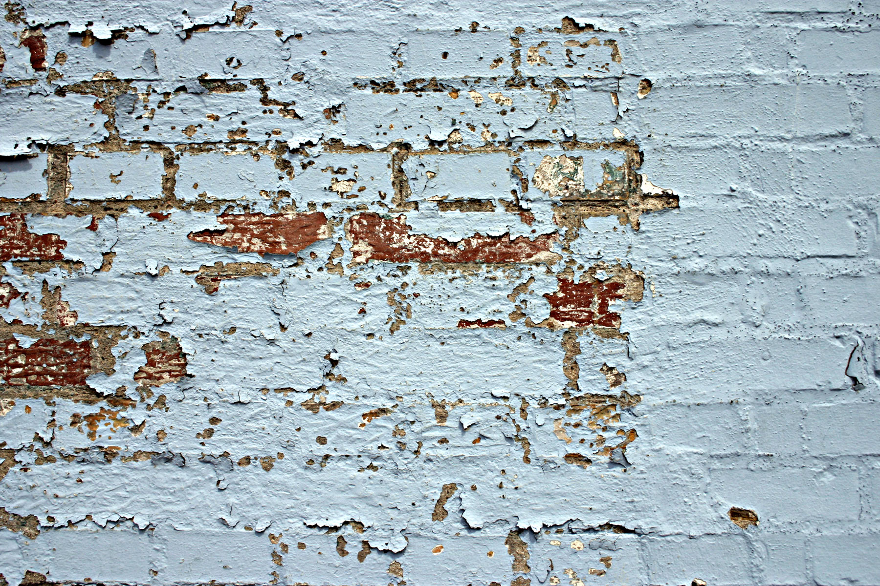 Peeled paint on a brick wall photo