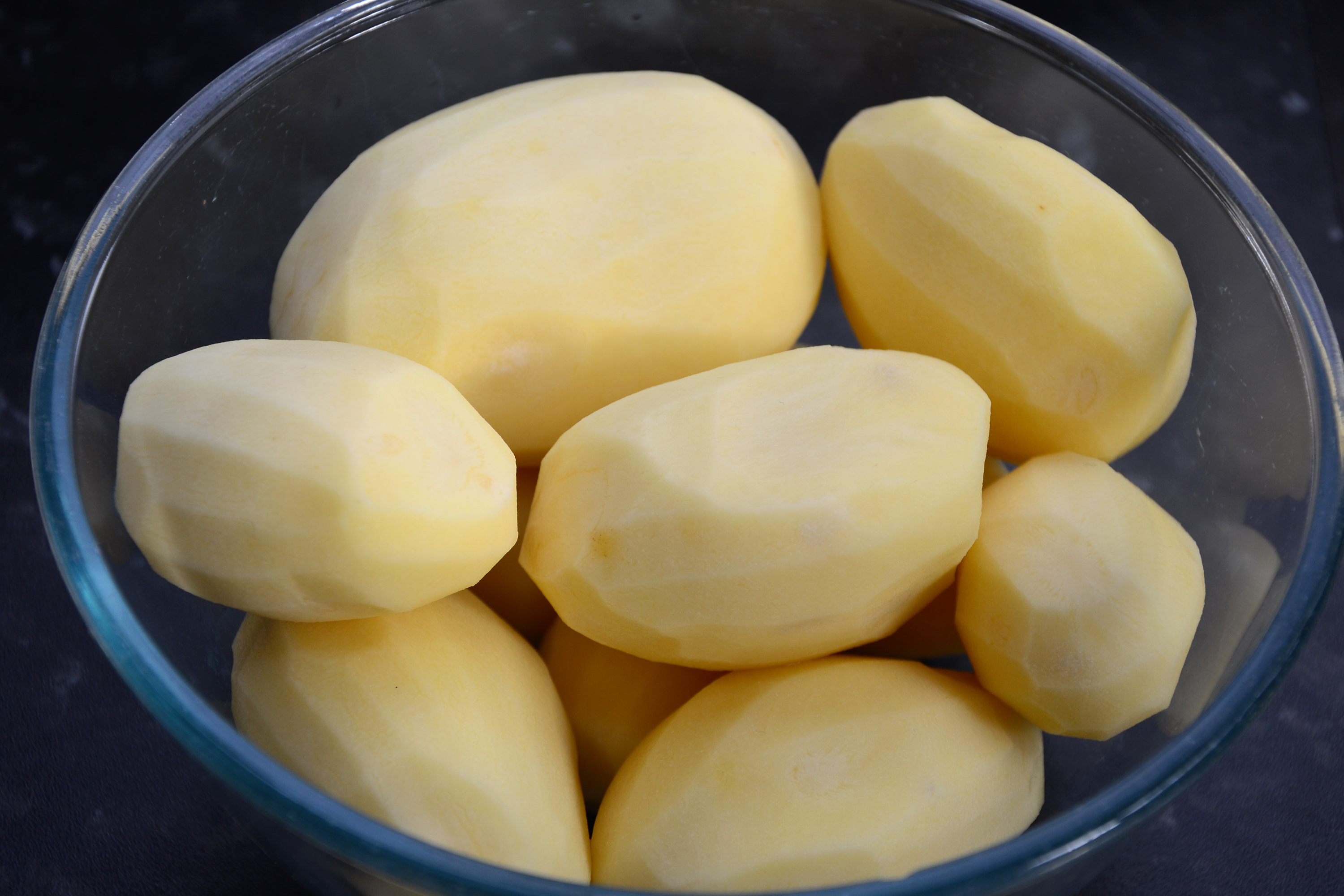 Peeled potatoes in a bowl photo