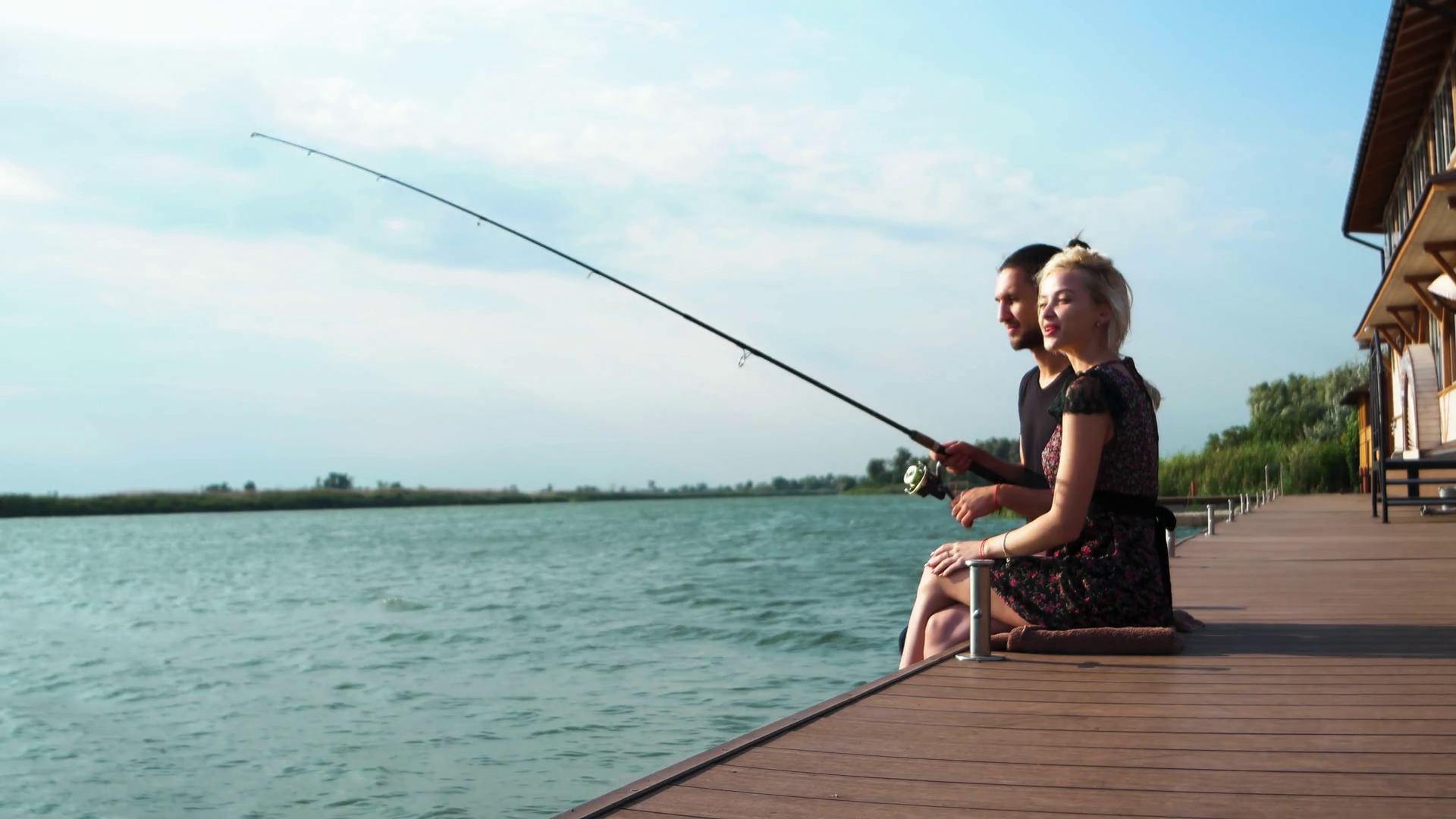 happy lovers fishing on spinning together at sunbeam, sweet couple ...