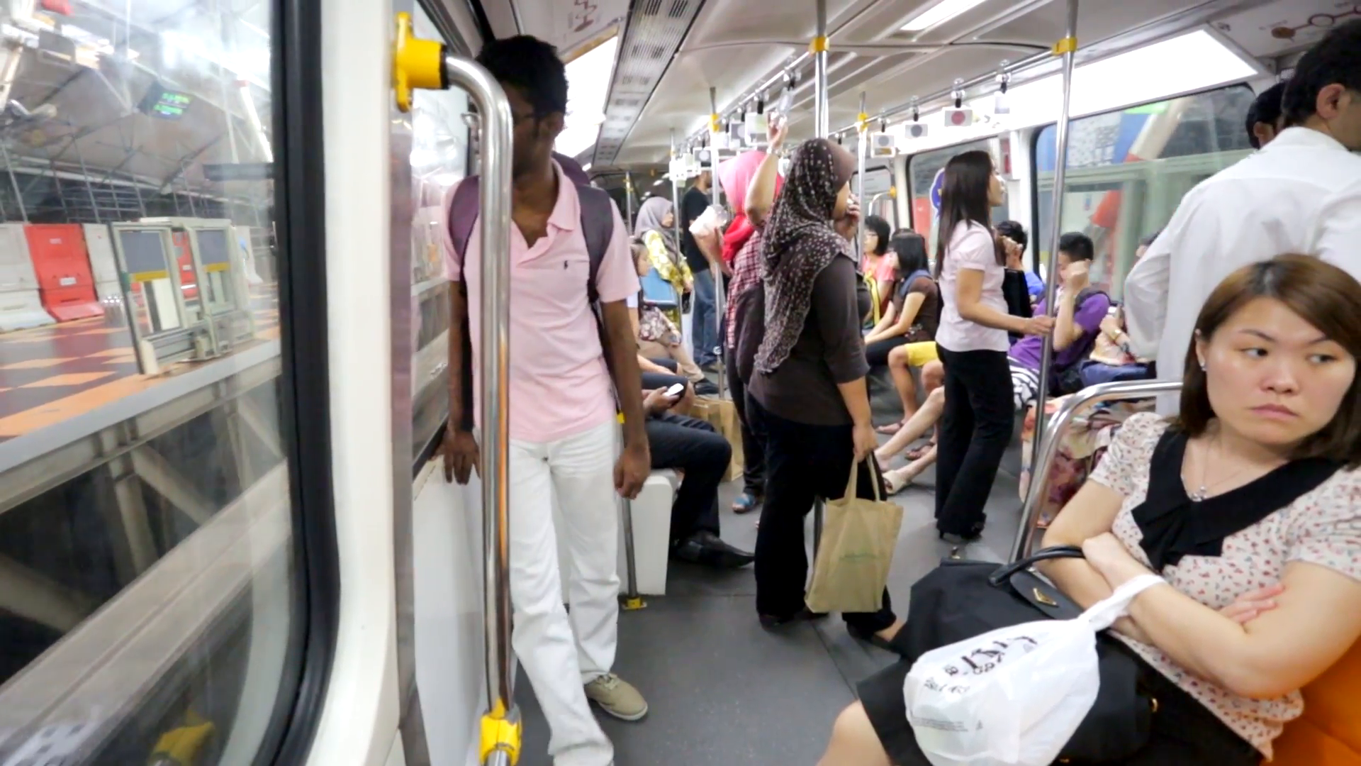 KUALA LUMPUR, MALAYSIA - CIRCA FEB 2014: People ride in monorail ...