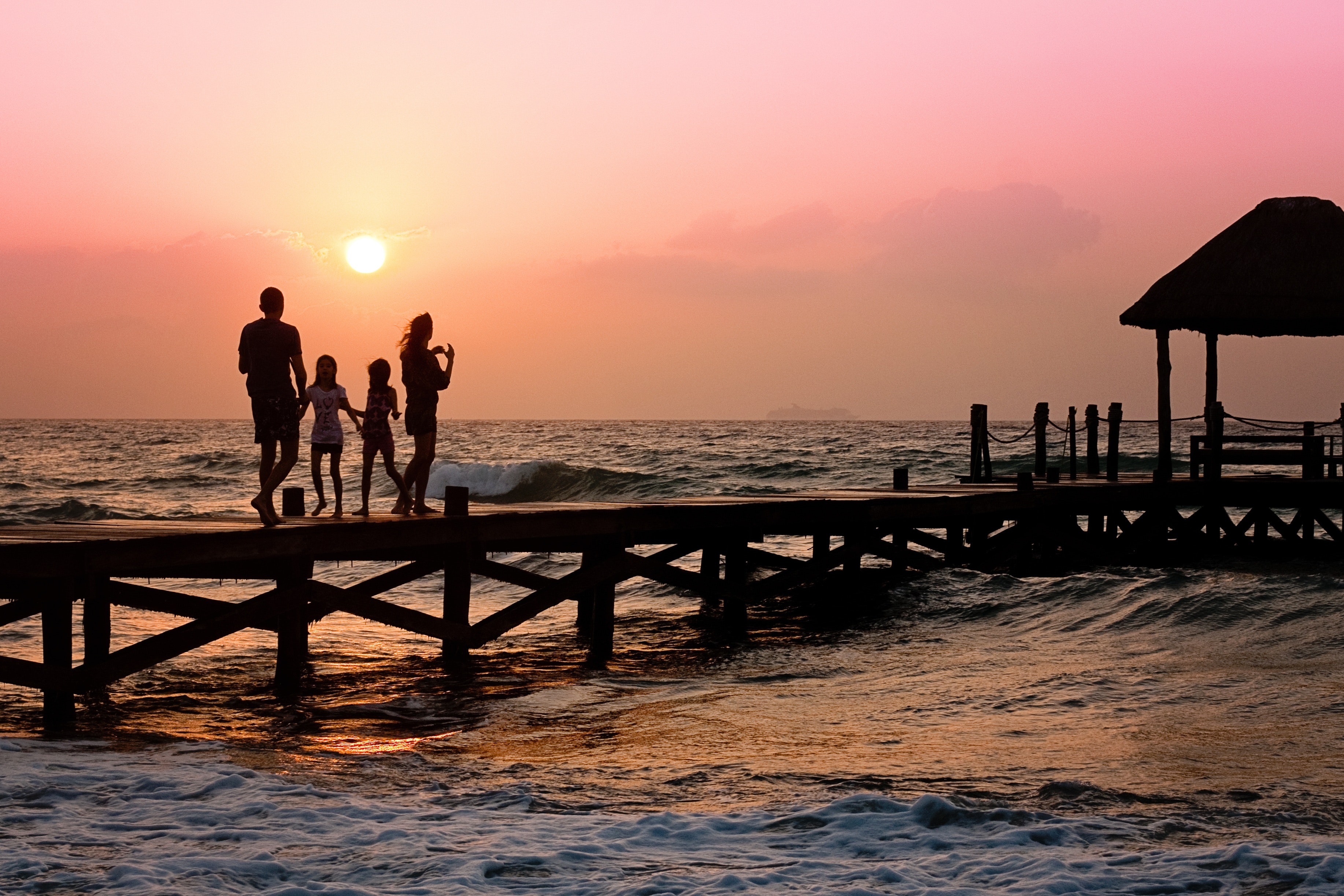 People standing on dock during sunrise photo