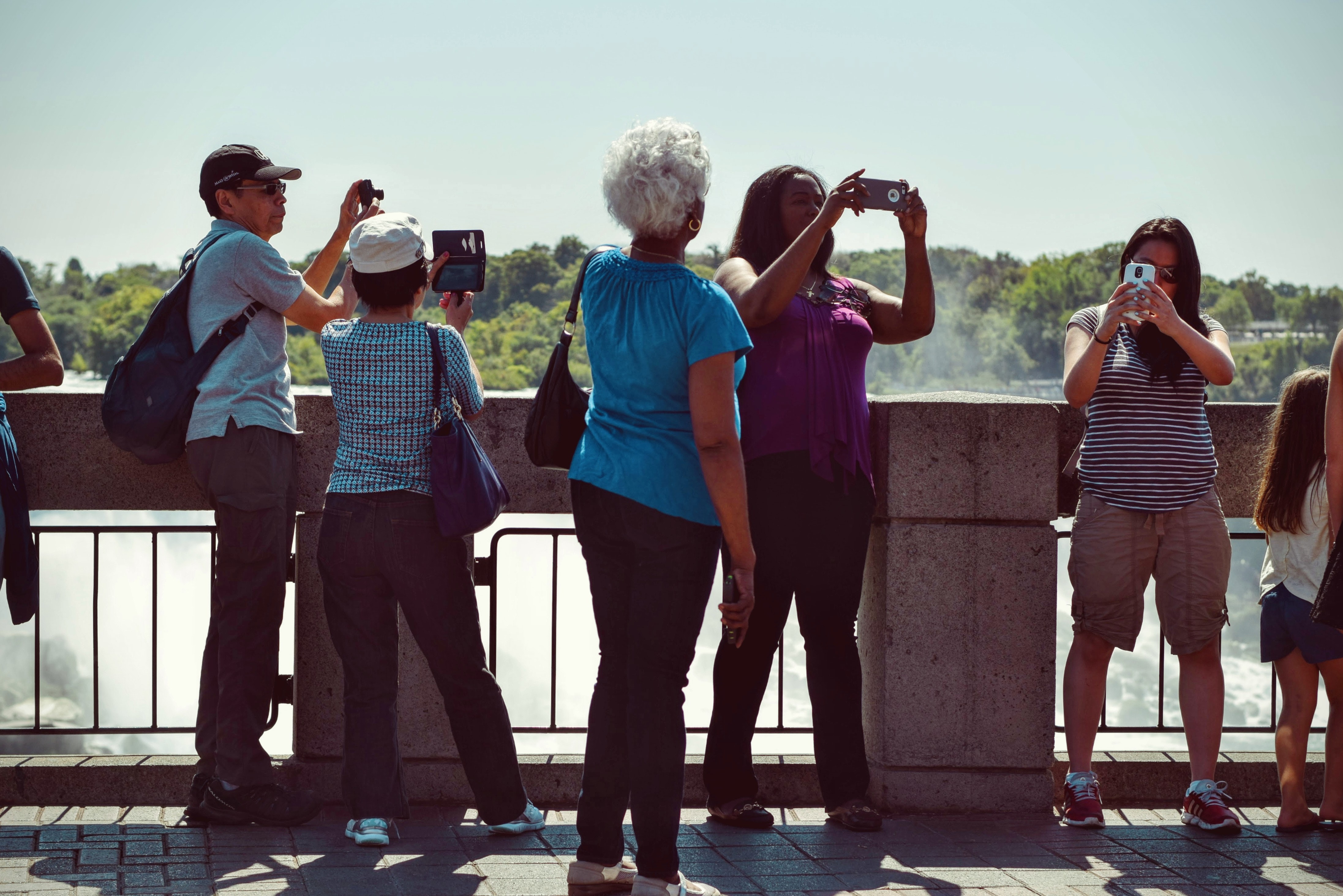 People taking pictures during daytime photo