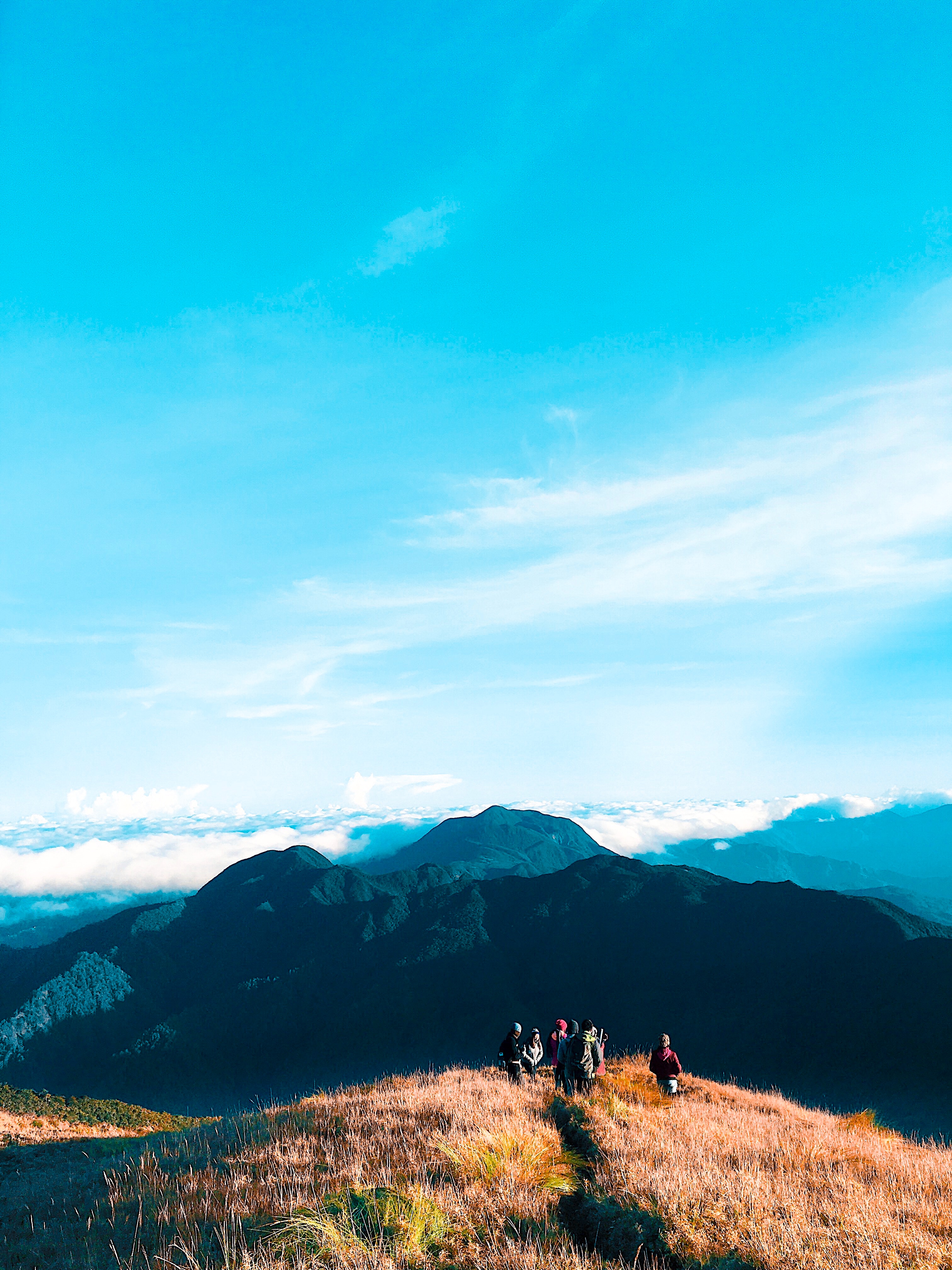 People walking on top of mountain photo