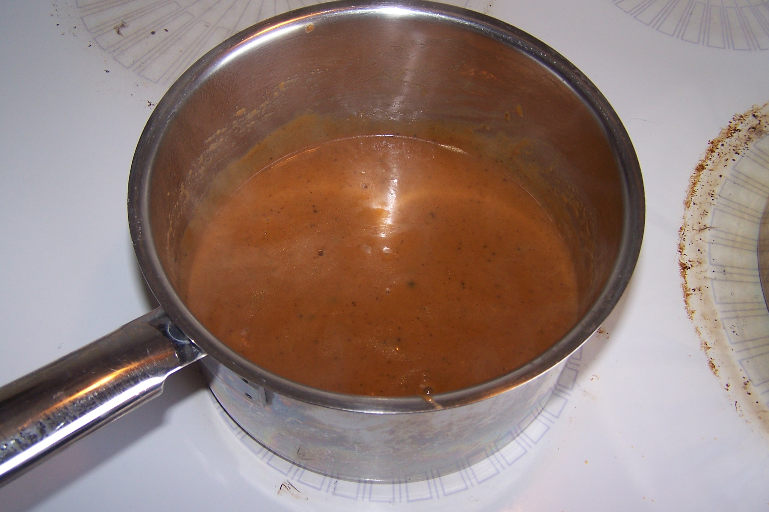 Peppercorn sauce in pan photo