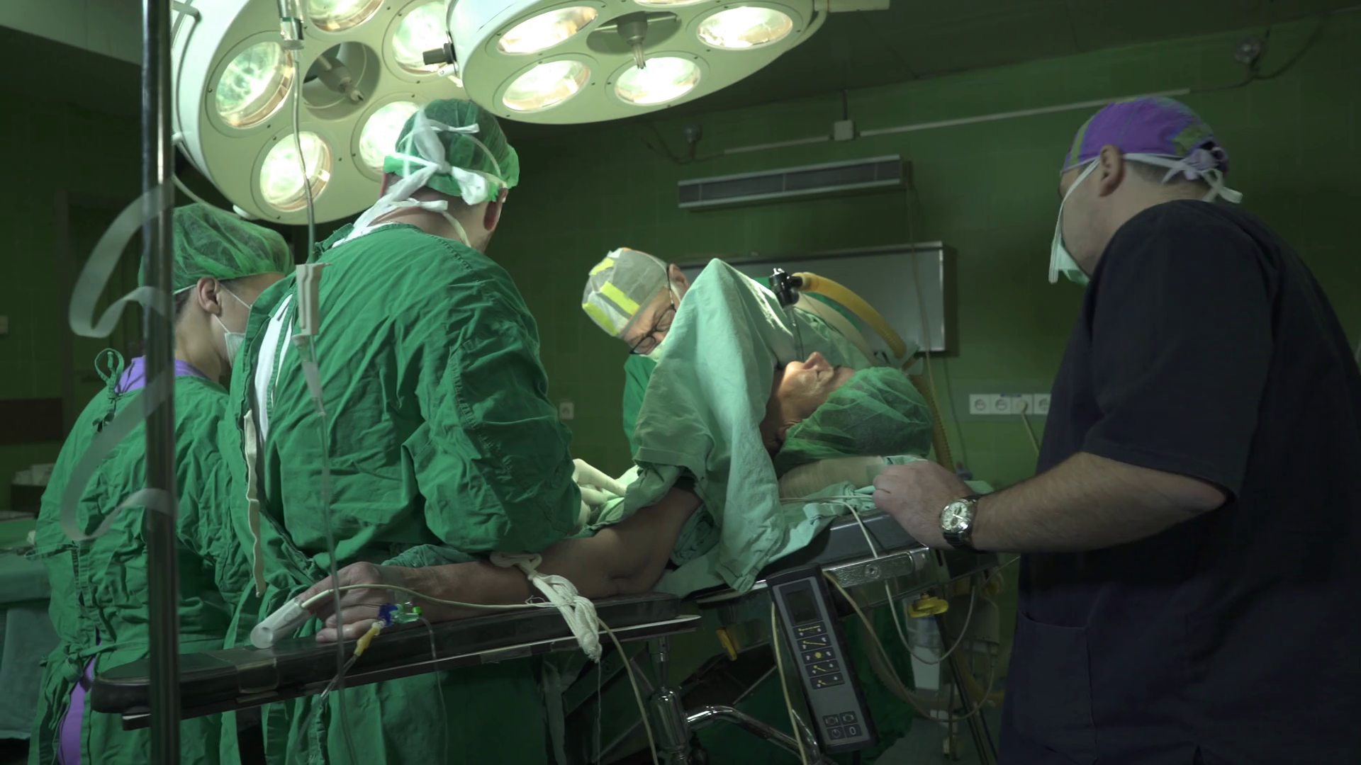Team of surgeons together with anesthesiologist and medical ...