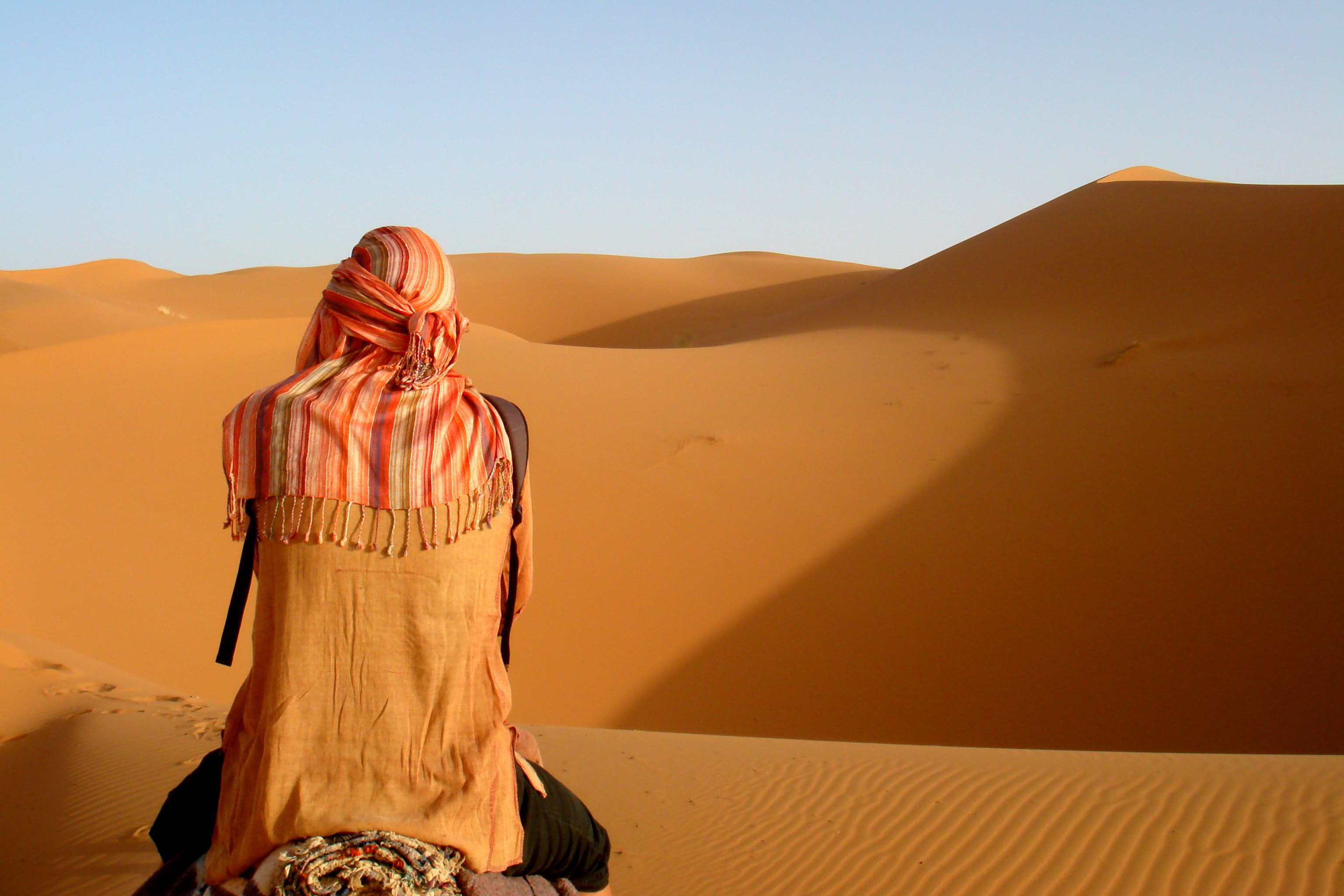 Person camel riding on desert photo
