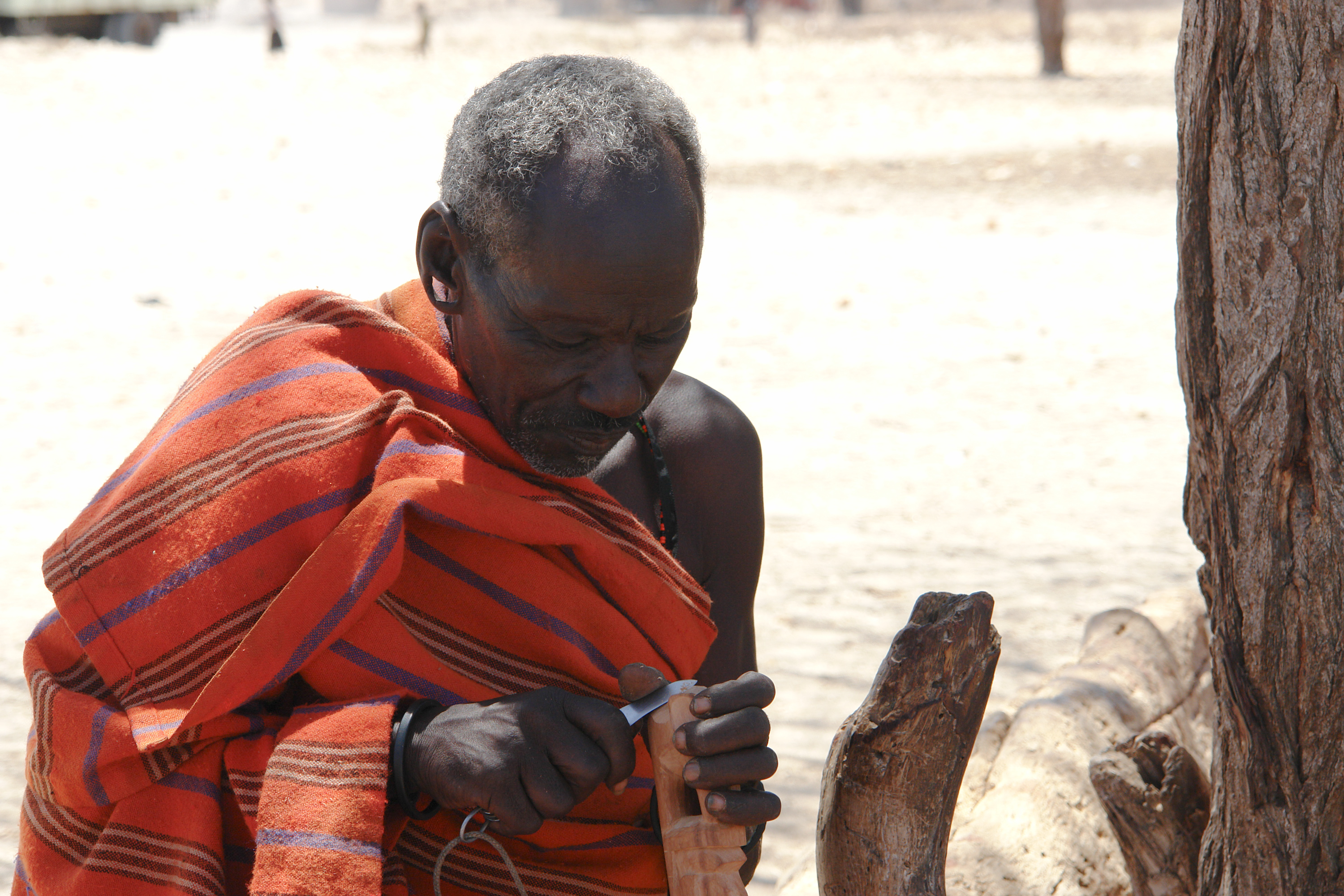 File:Samburu man carving wood.jpg - Wikimedia Commons