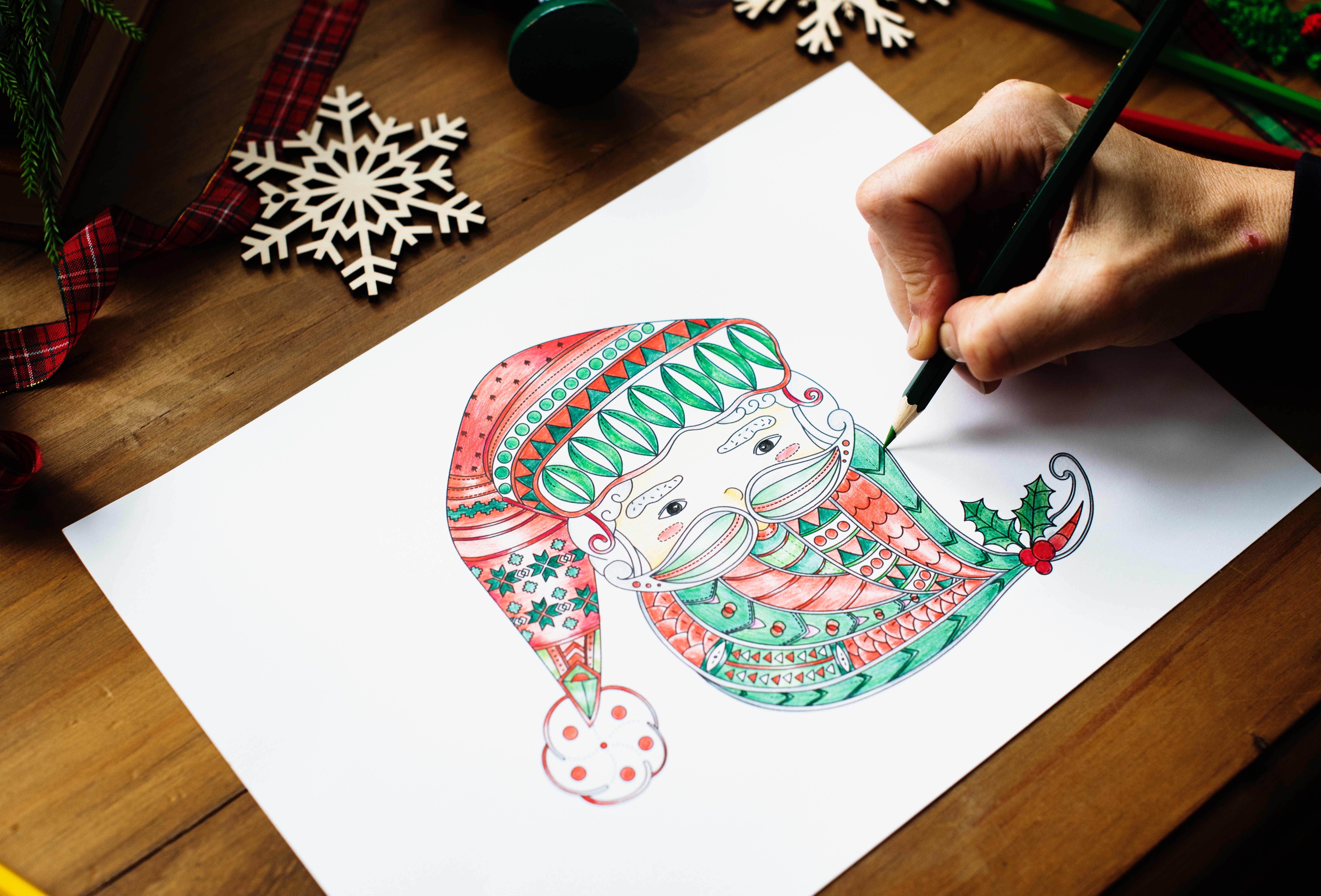 Person drawing gnome on white printer paper photo