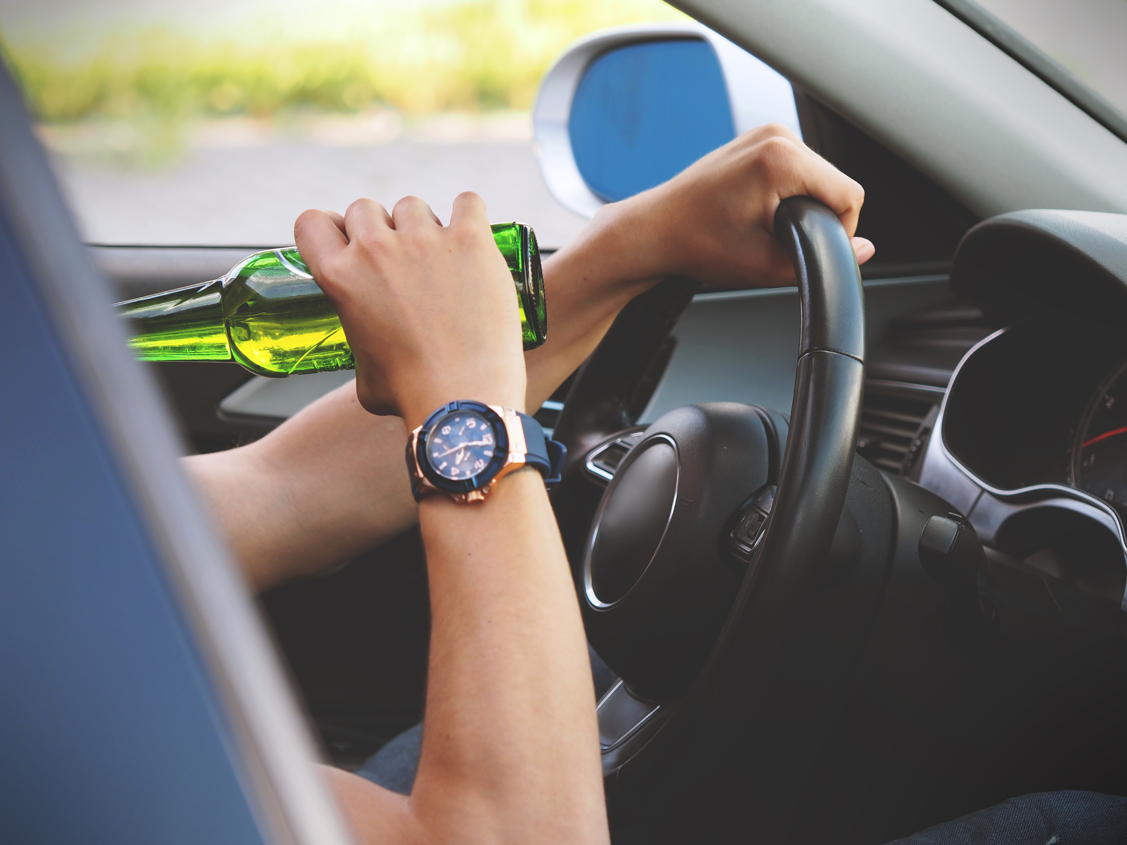 Person driving and drinking photo