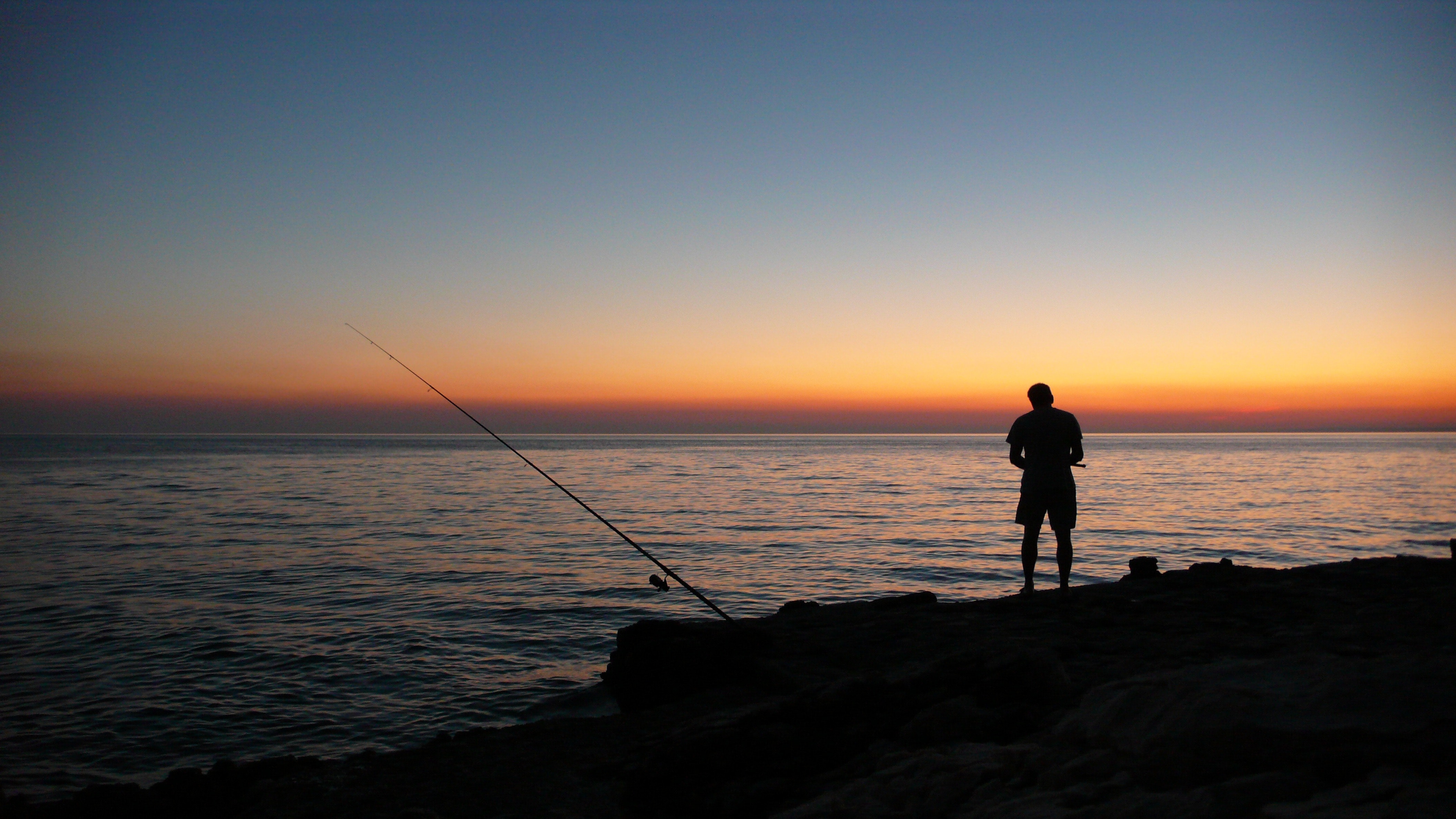 Person fishing during sunset photo