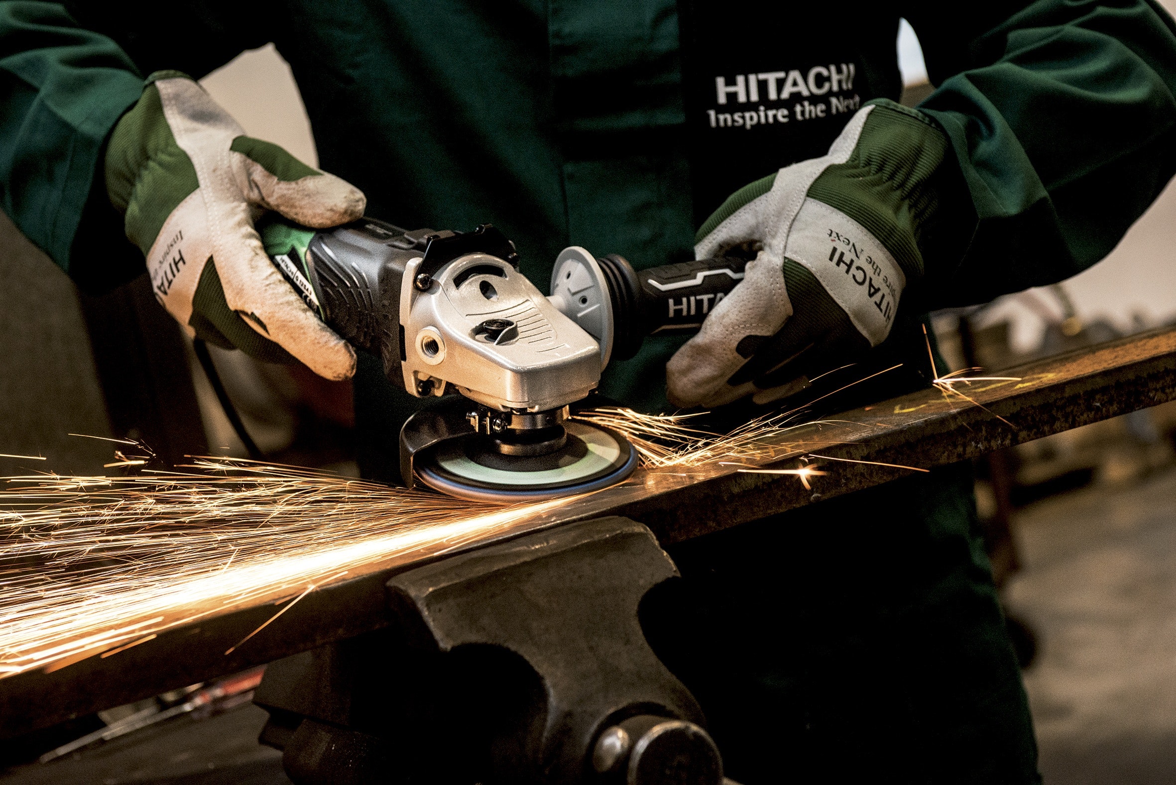 Person holding black and gray hitachi angle grinder photo