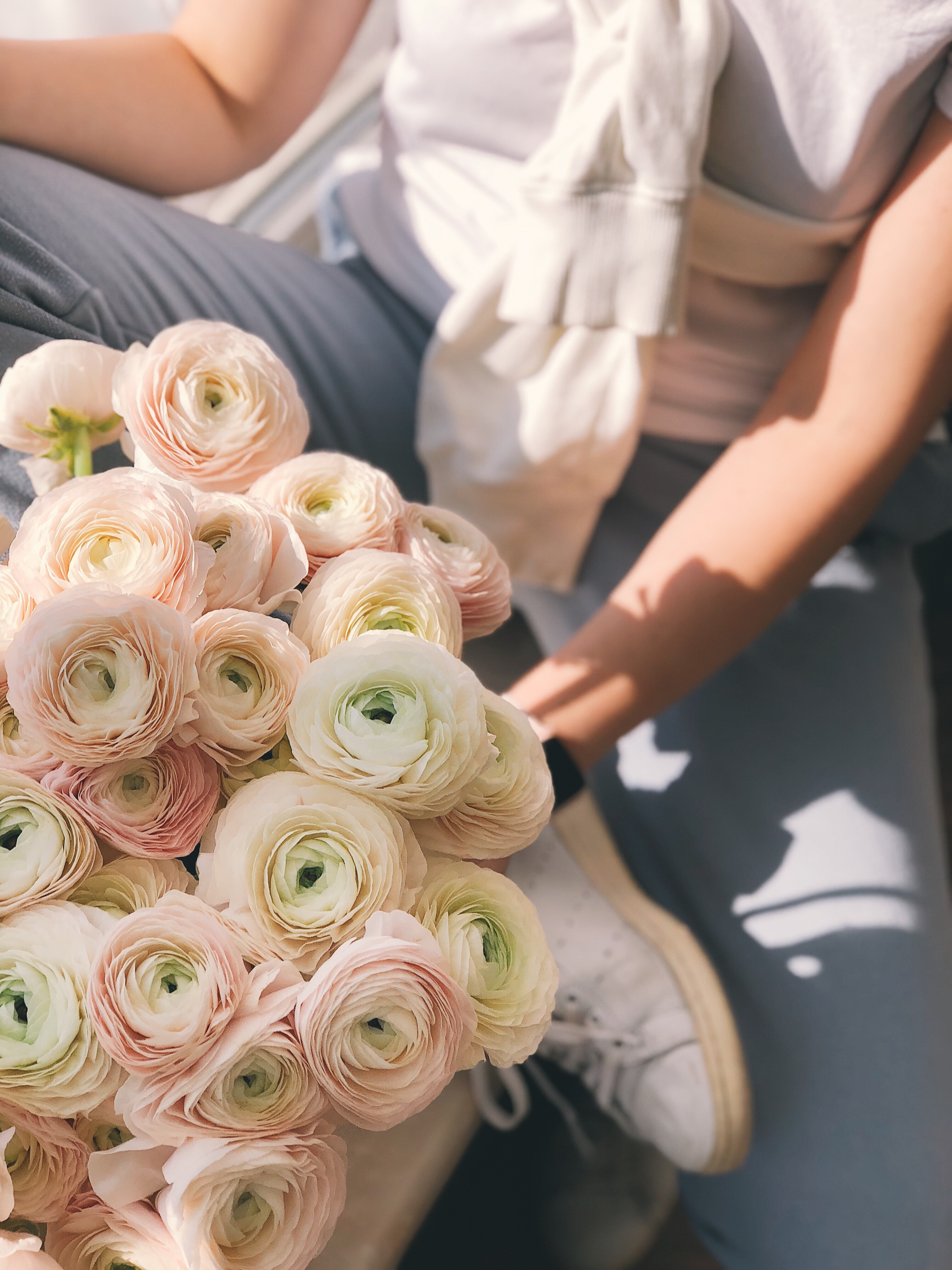 Person holding bouquet of pink and green flowers photo