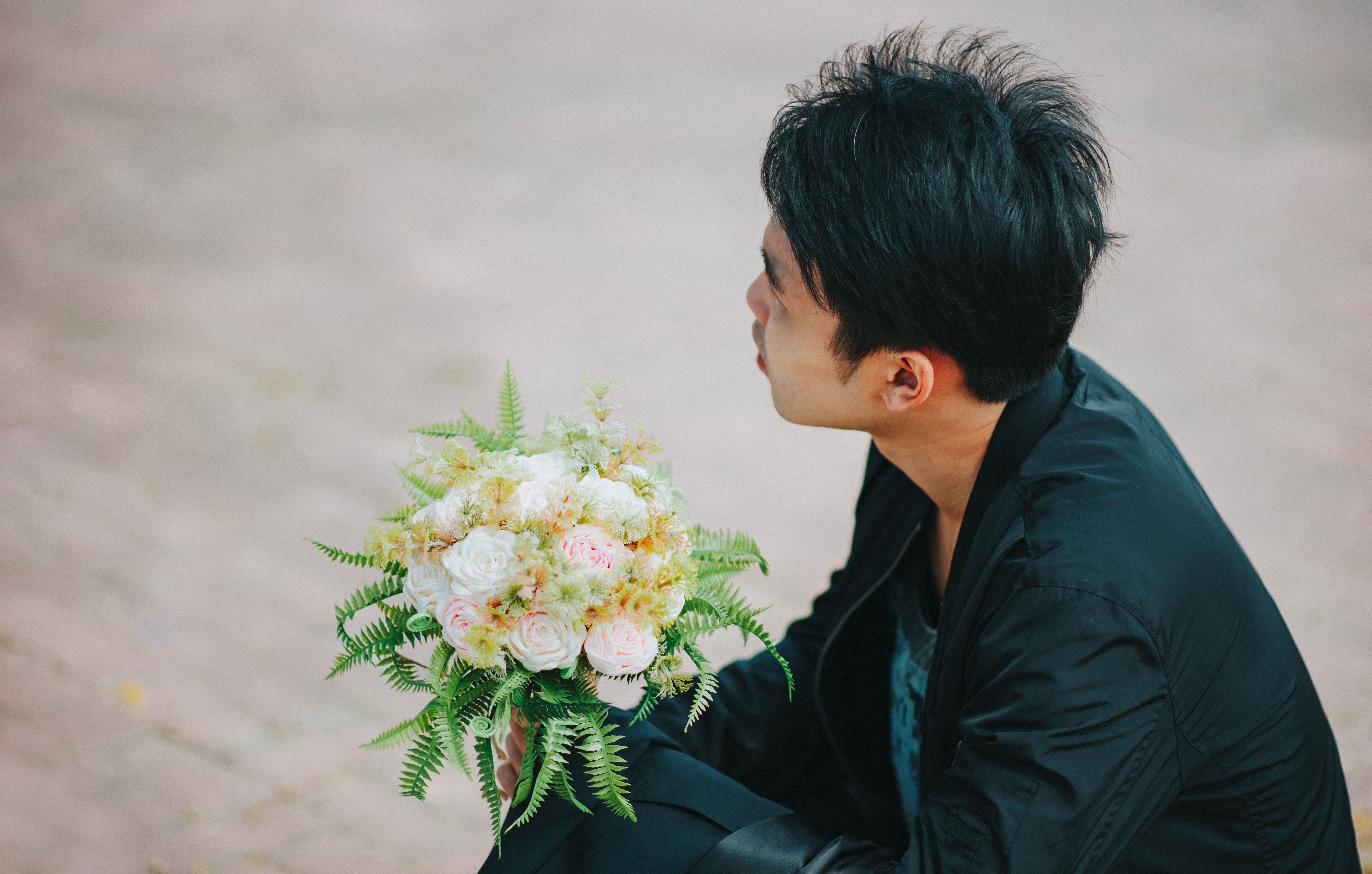 Person holding bouquet of roses photo