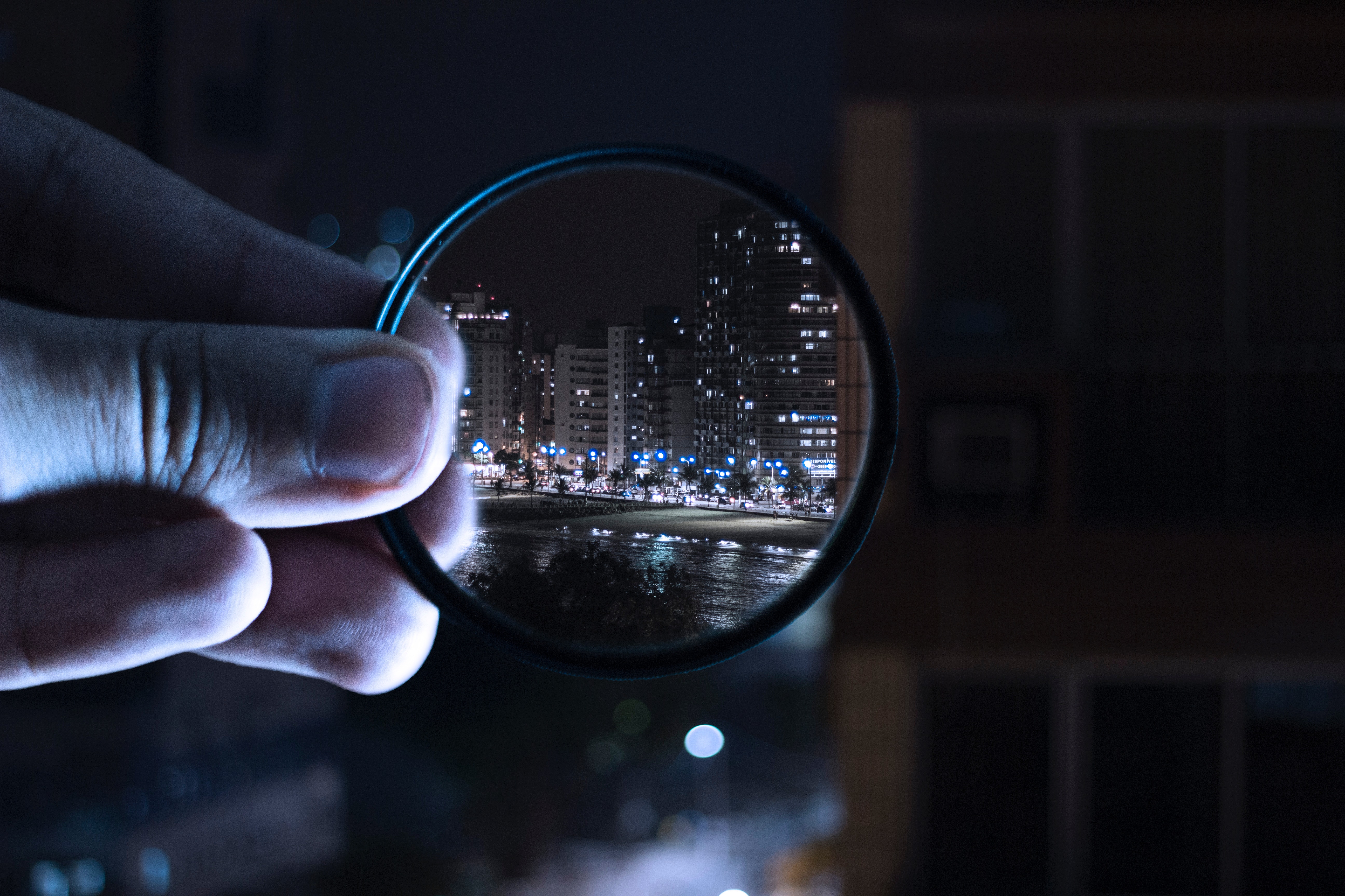 Person holding magnifying glass photo