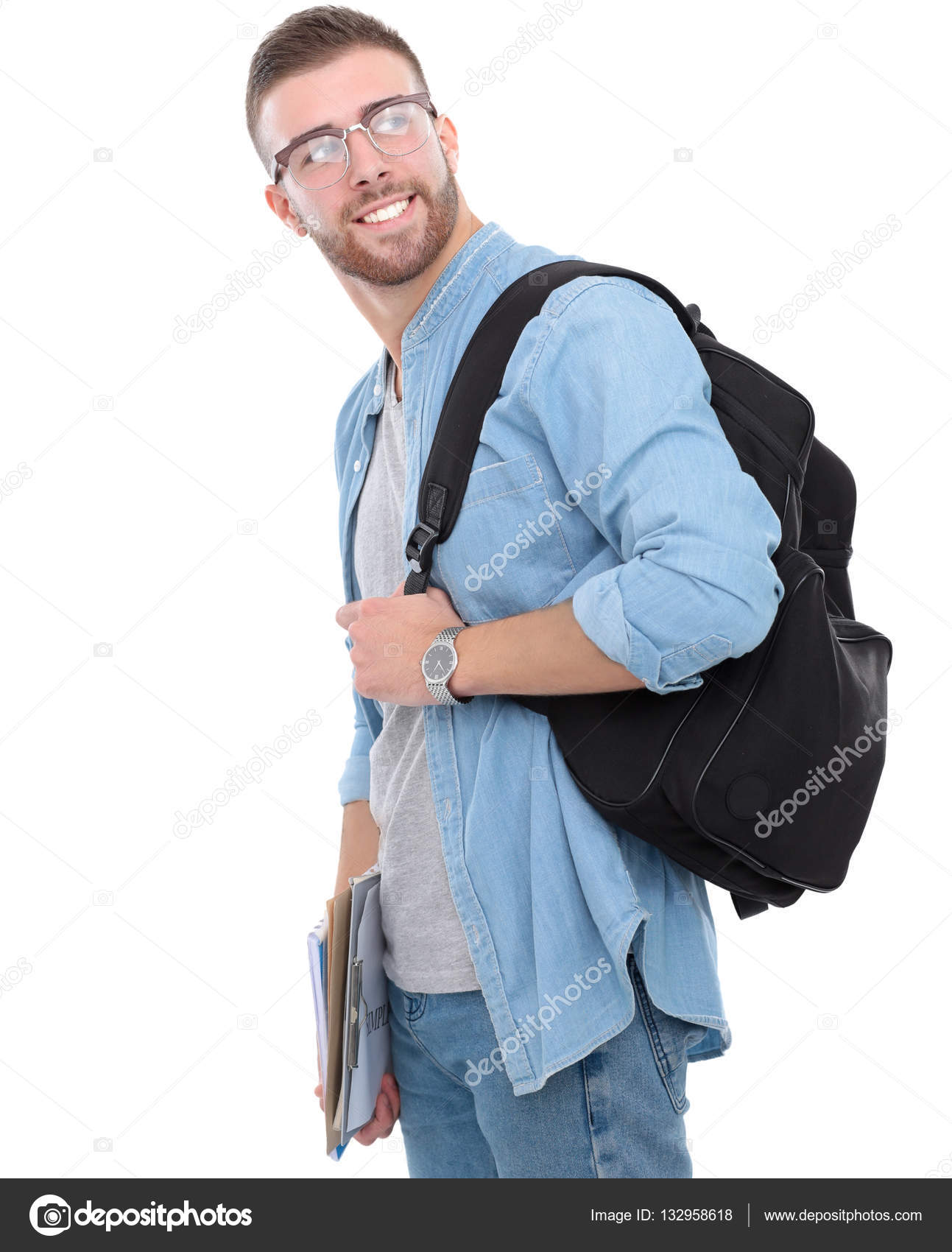 Young male student with school bag holding books isolated on white ...
