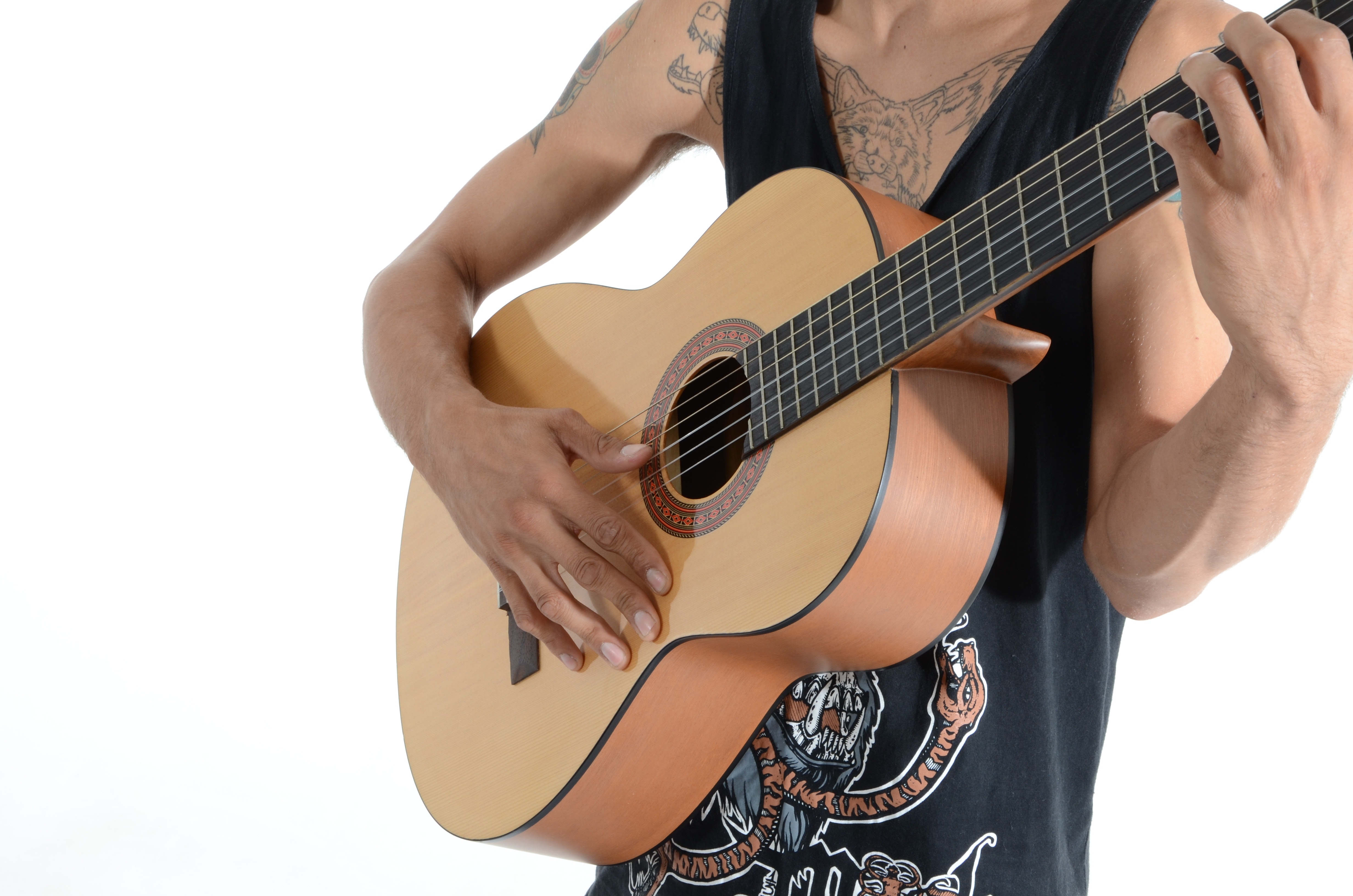 Person in black tank top playing acoustic guitar photo
