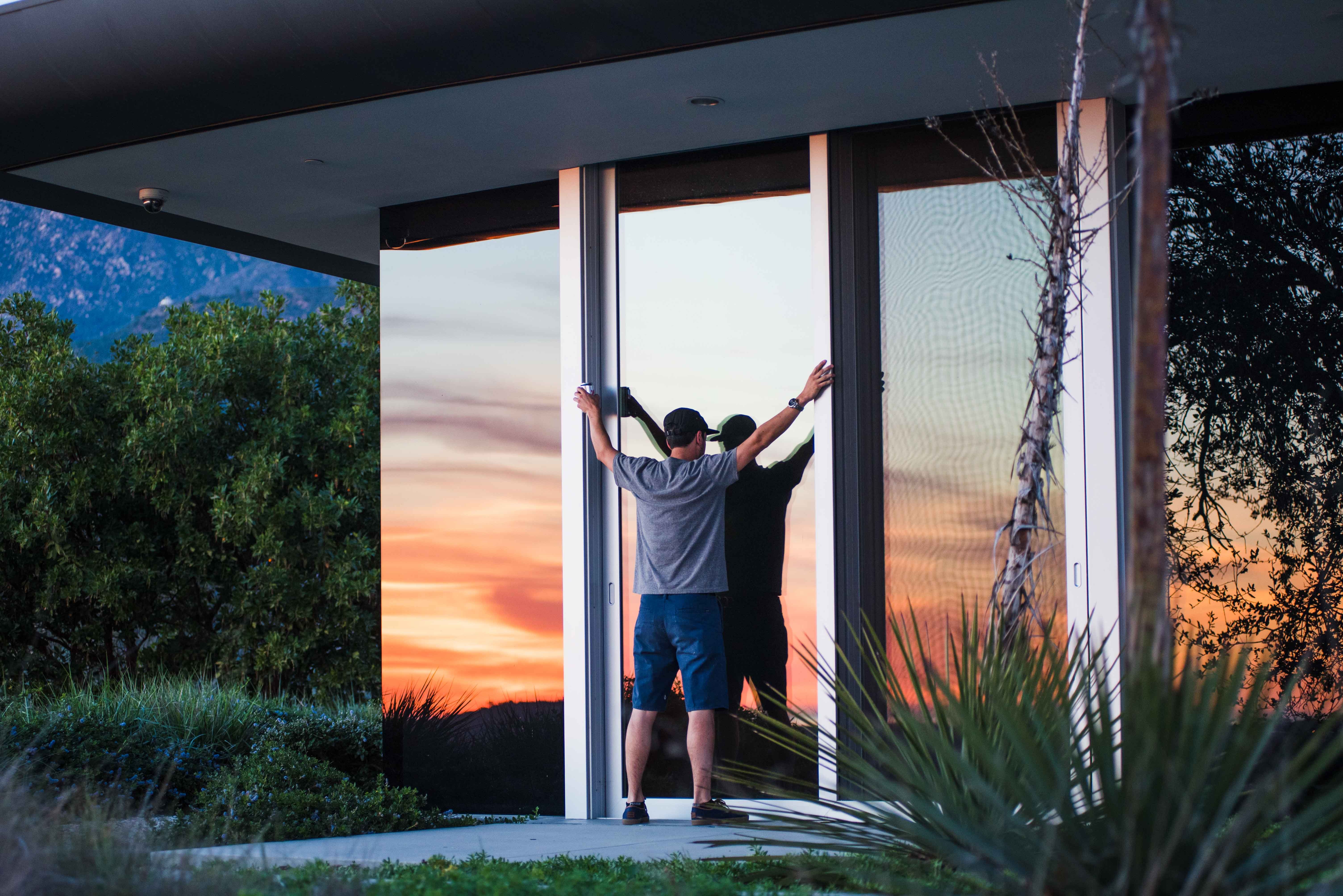 Person in gray shirt and blue shorts standing during dawn photo
