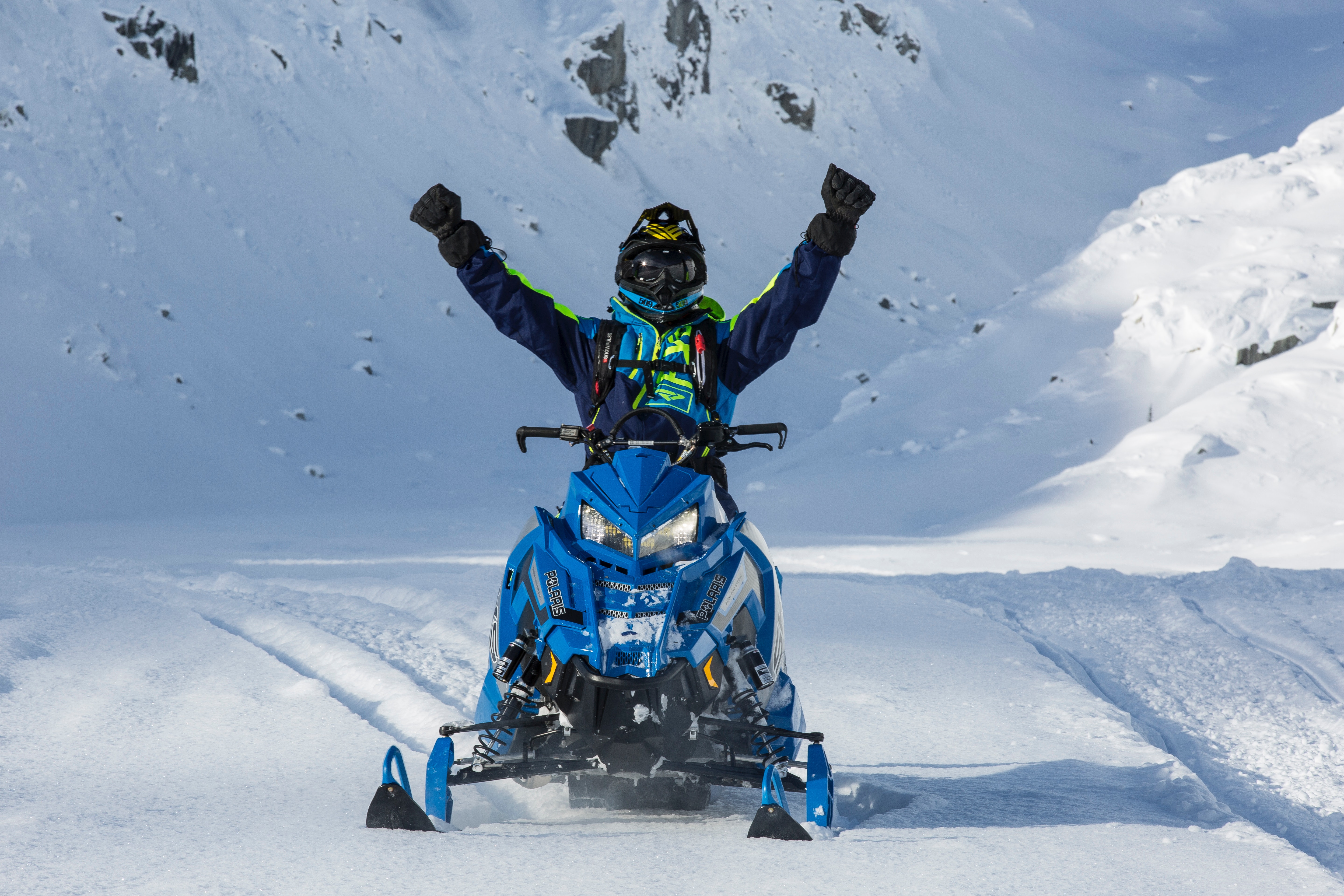 Person riding blue snow mobile photo