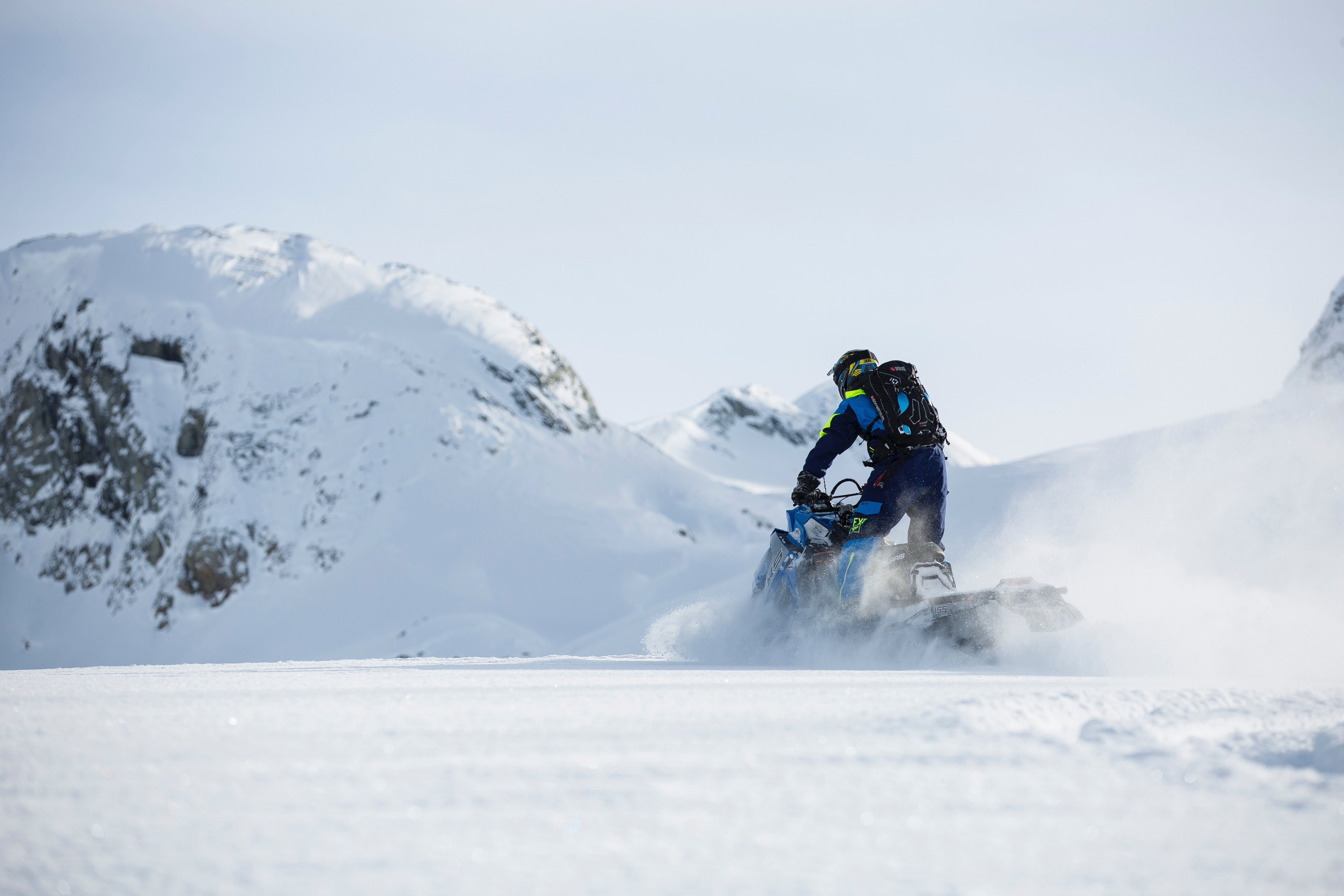 Person riding on snowmobile during winter photo