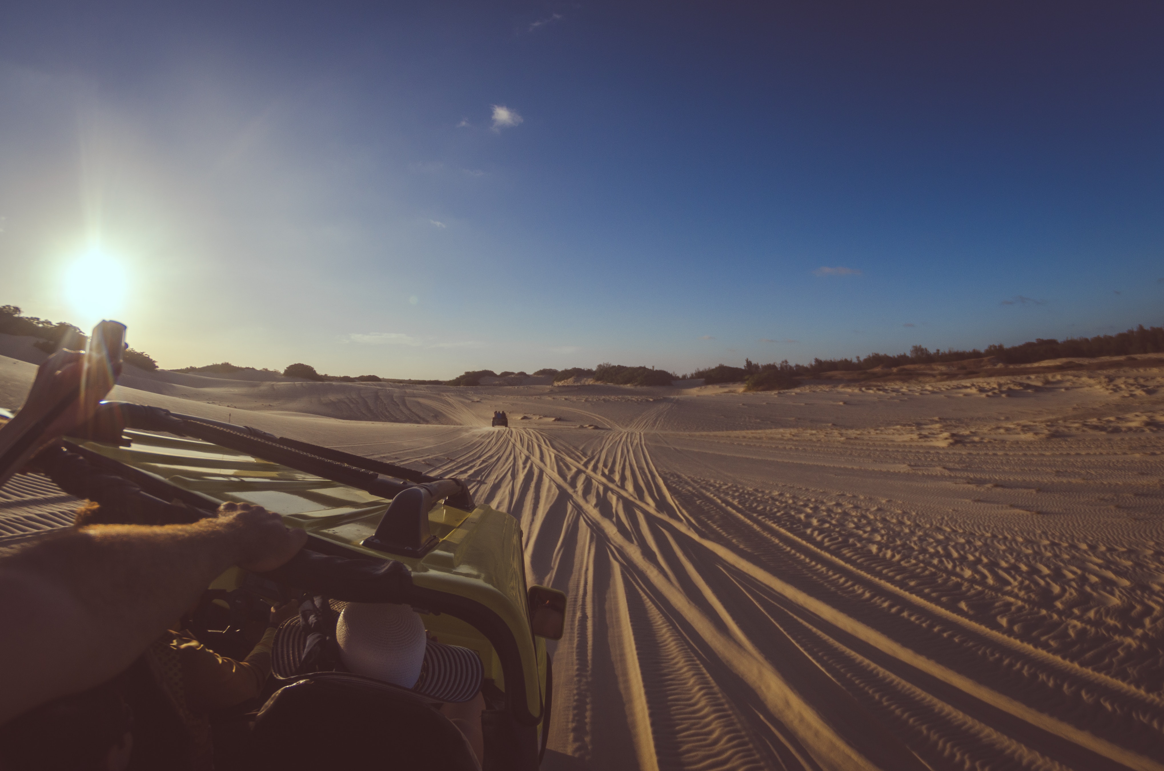 Person riding yellow dune buggy photo