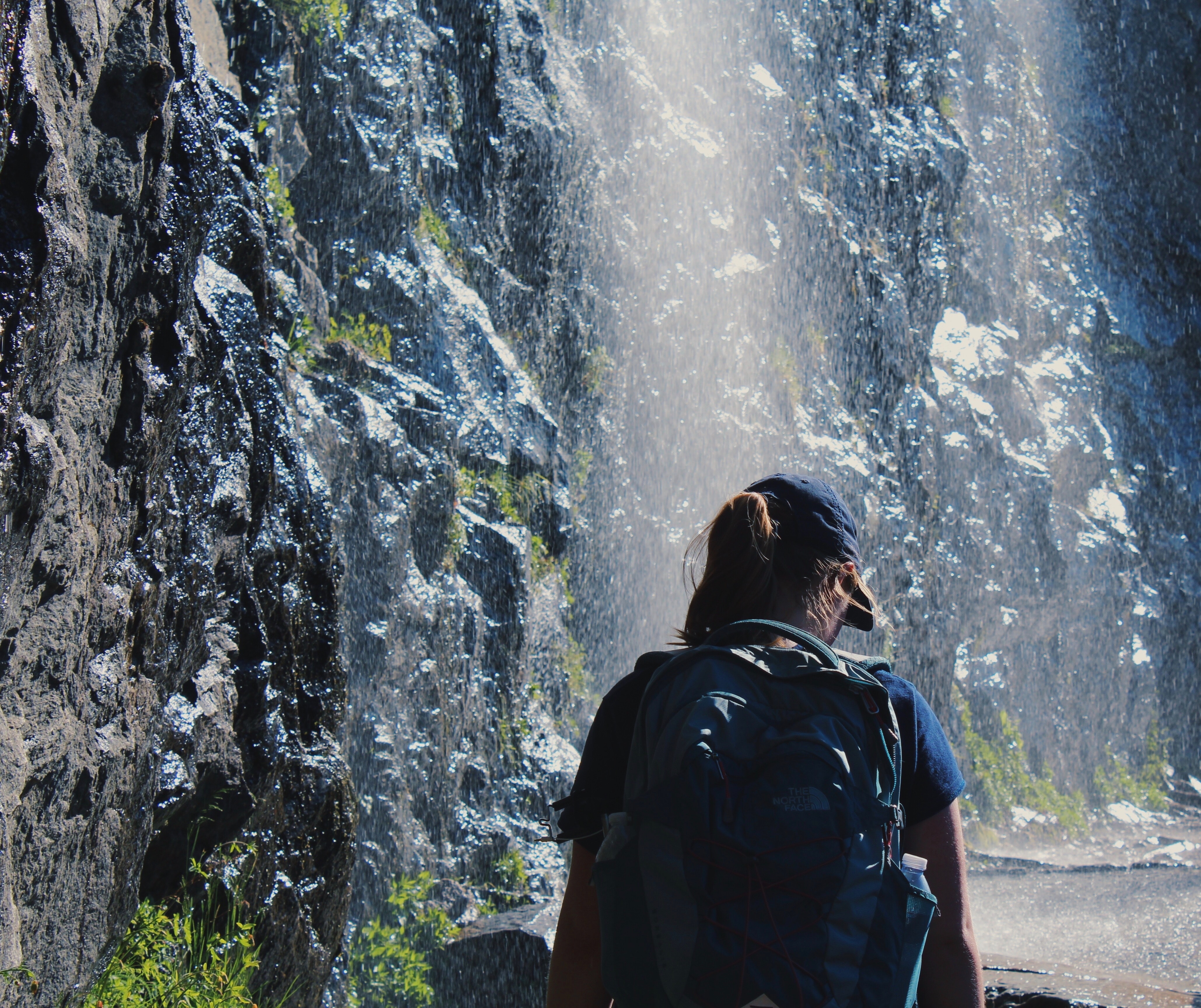 Person walking under waterfalls photo