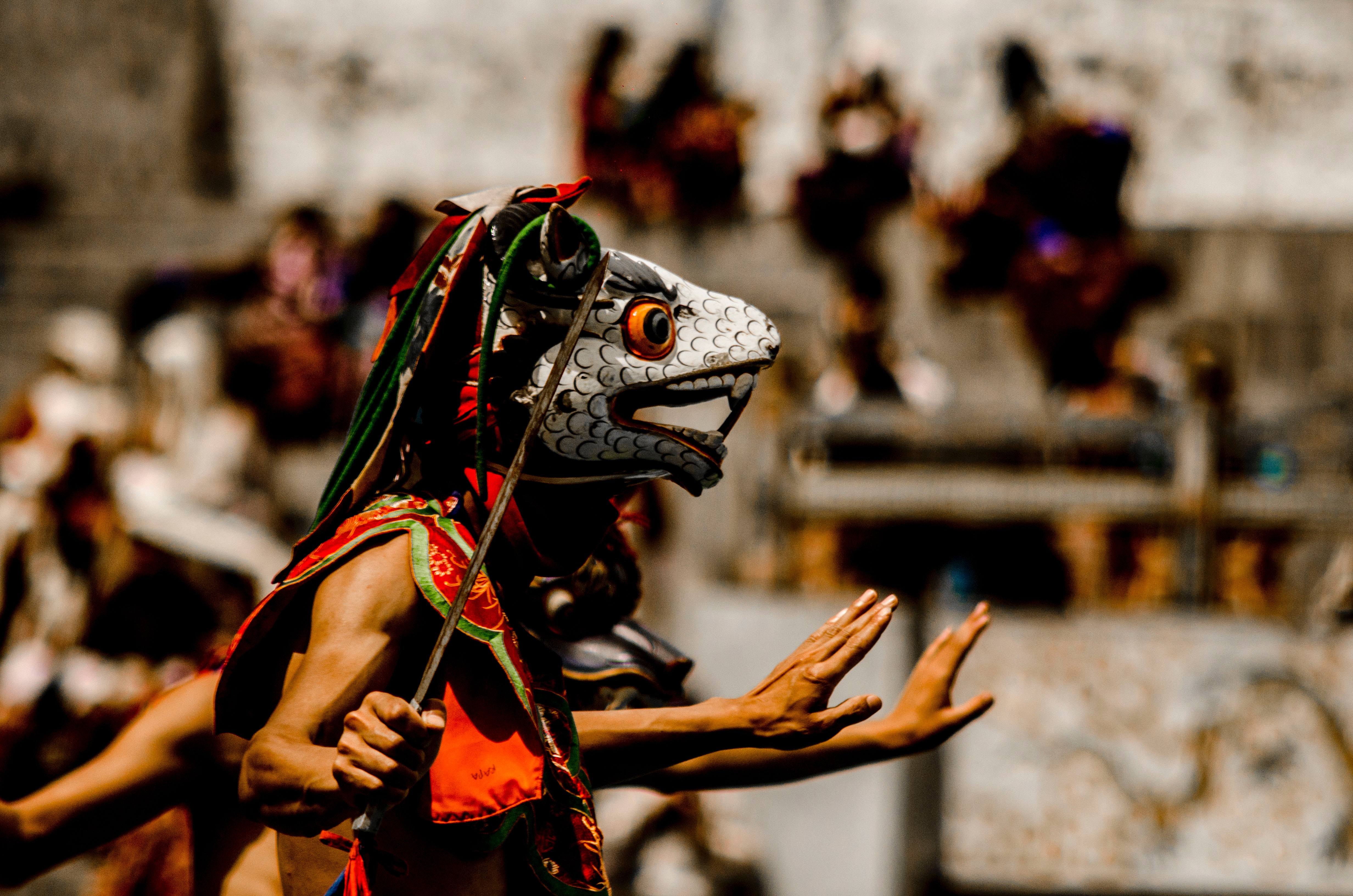Person wearing traditional mask dancing photo