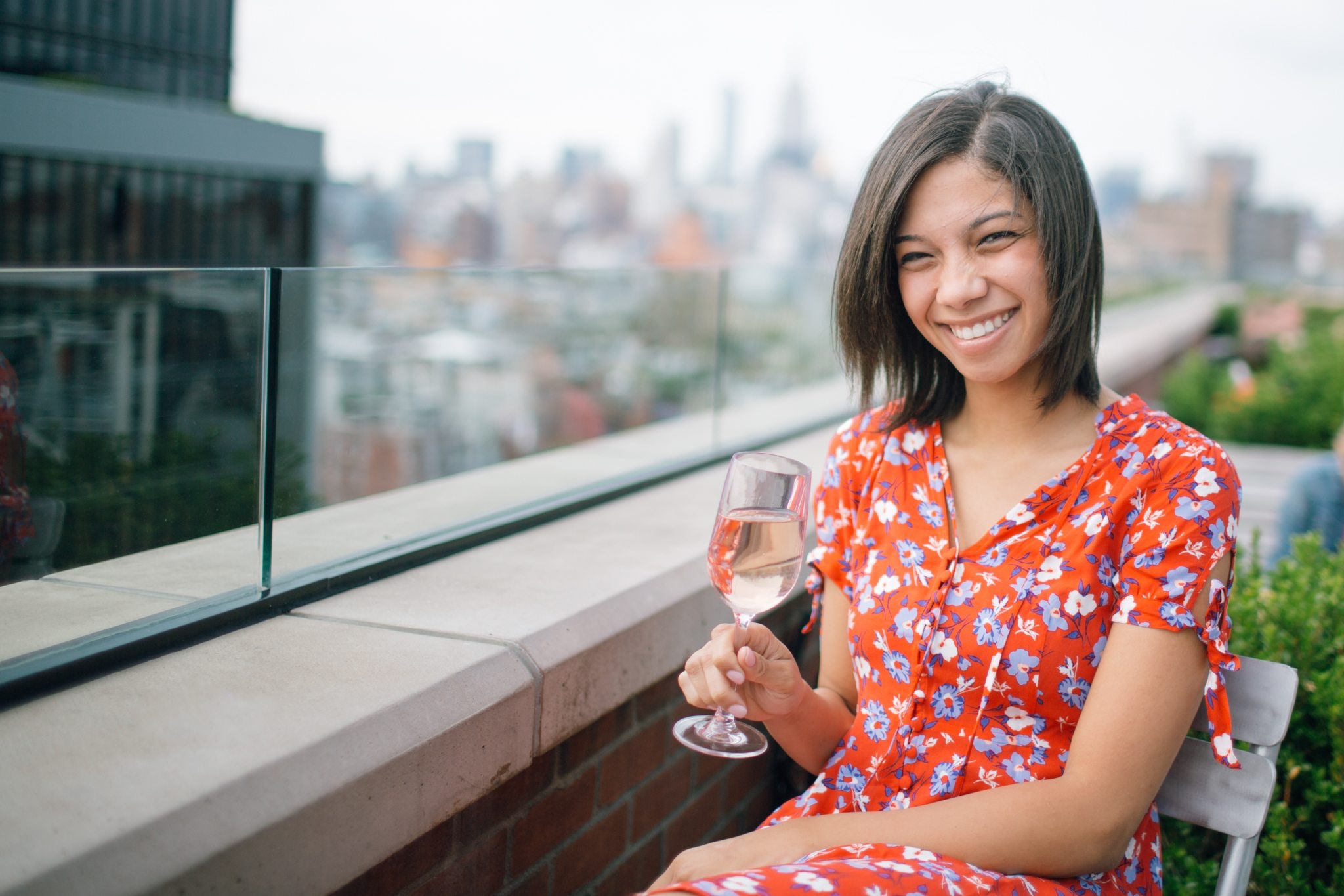 Photo of a woman sitting on chair holding wine glass