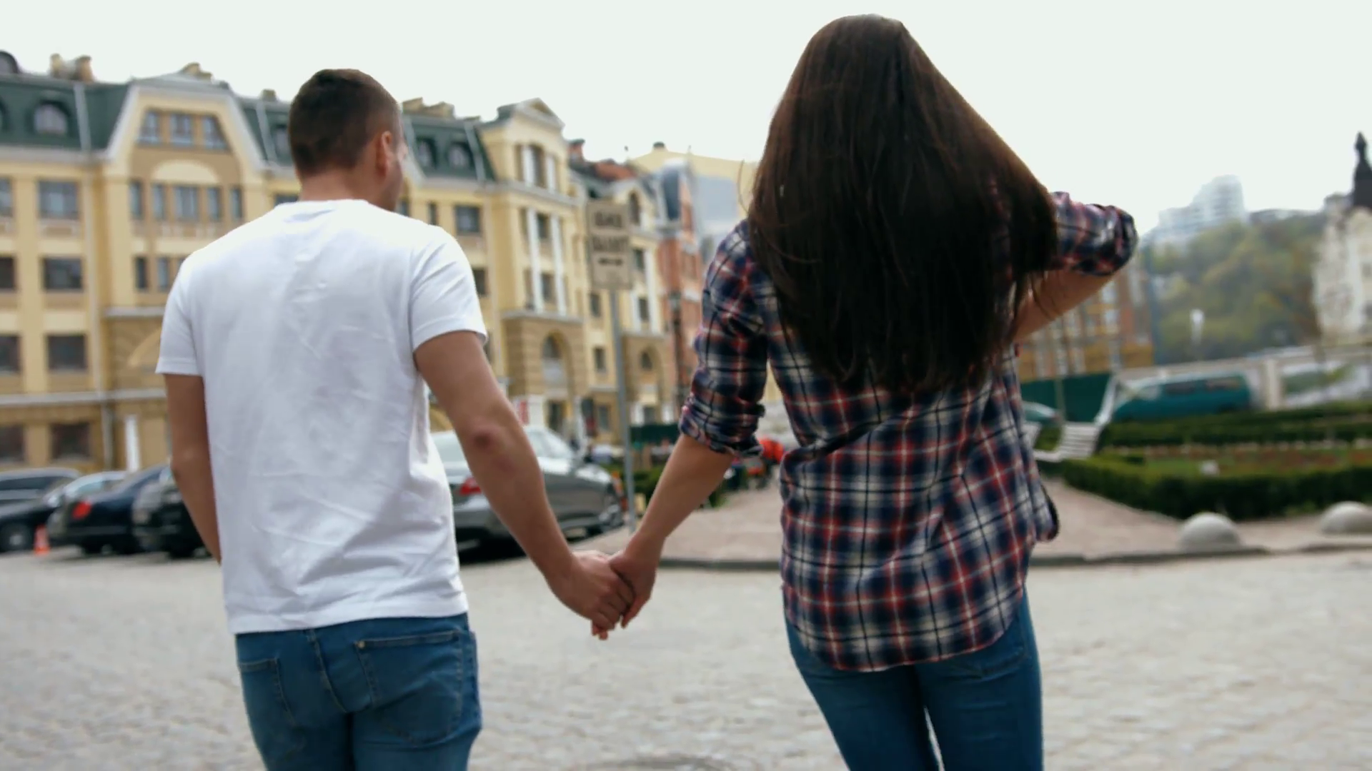 Young beautiful sweet couple walking holding hands in the city ...