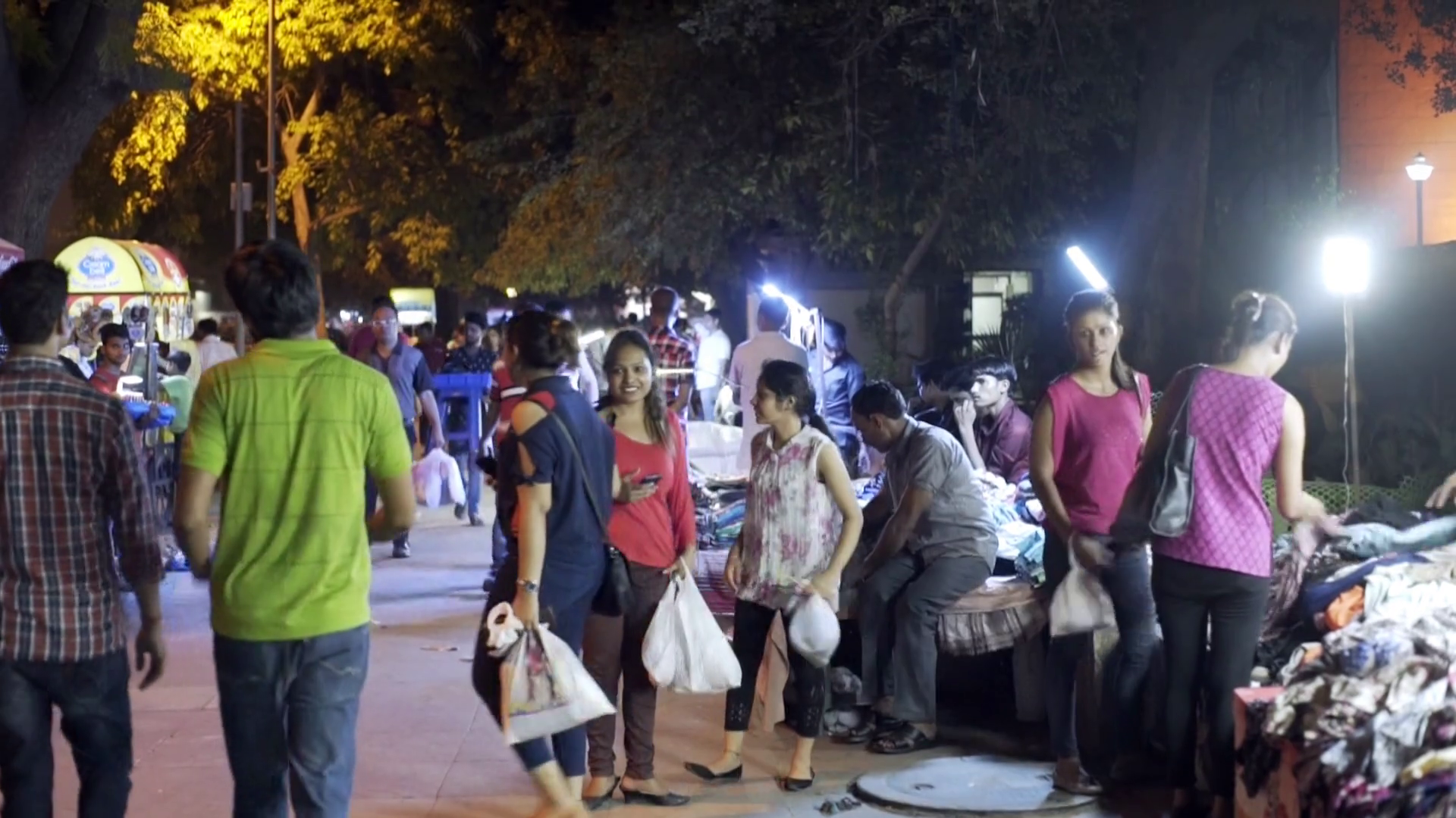 Busy nighttime market bazaar, crowd of people walk, New Delhi, India ...